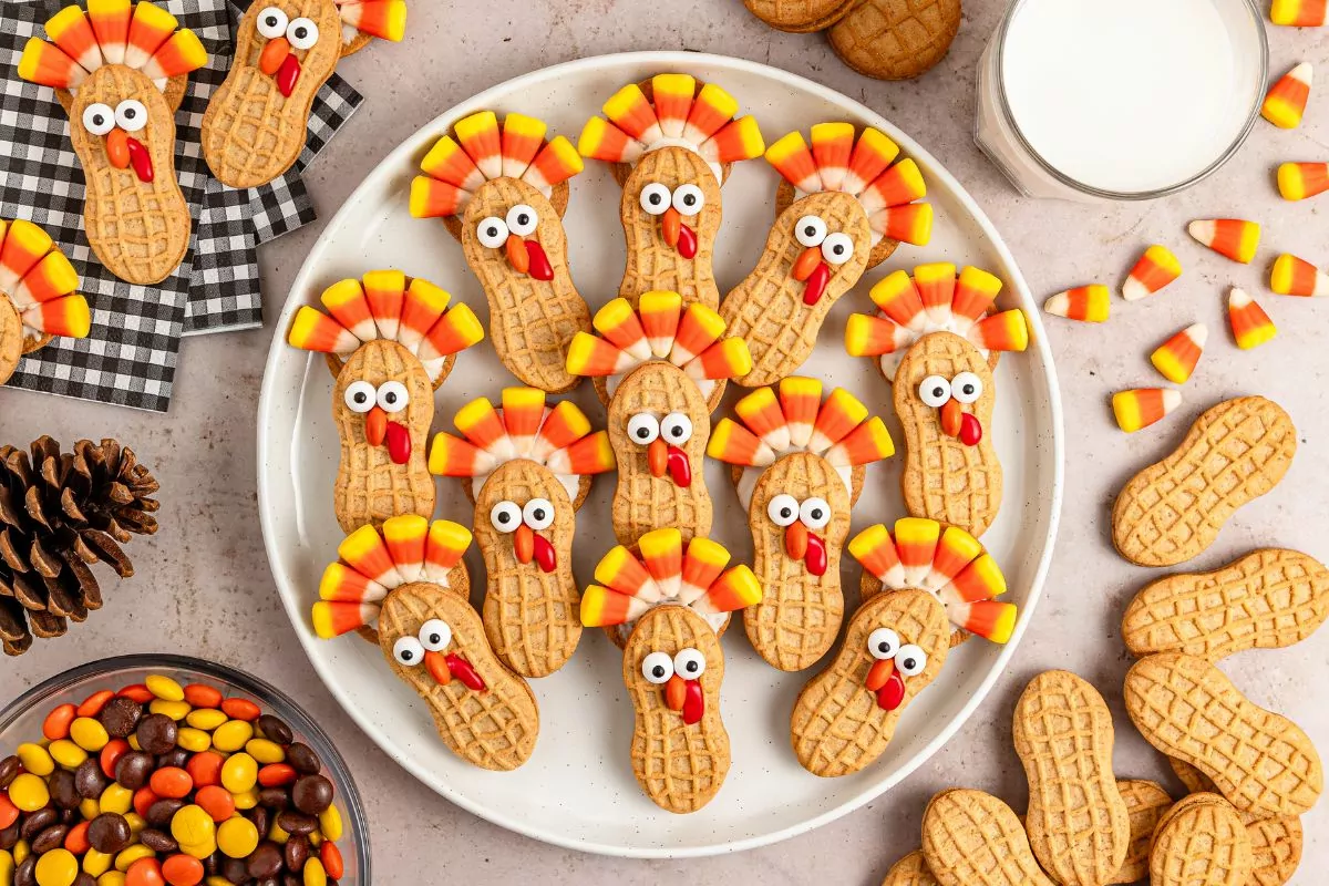 Nutter Butter Turkeys on a round white platter with the ingredients to make them around the platter in piles