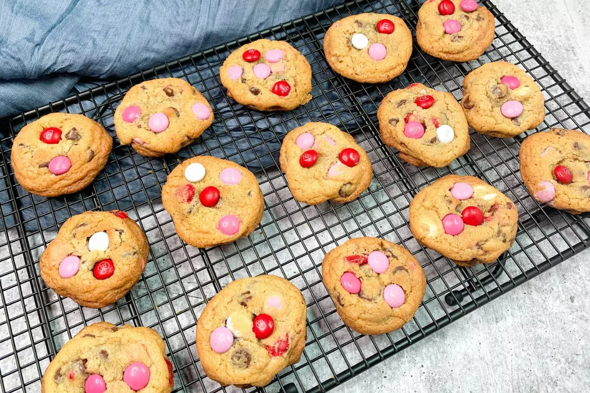 chocolate chip cookies with pink, red and white candy pieces.