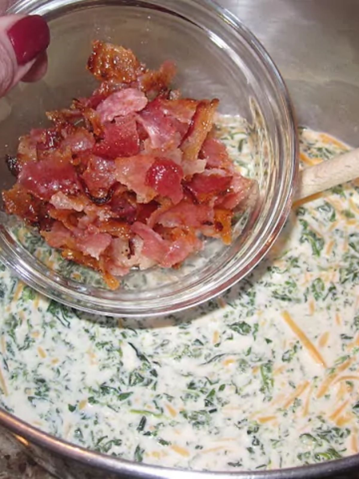 adding chopped cooked bacon to bowl of quiche batter.