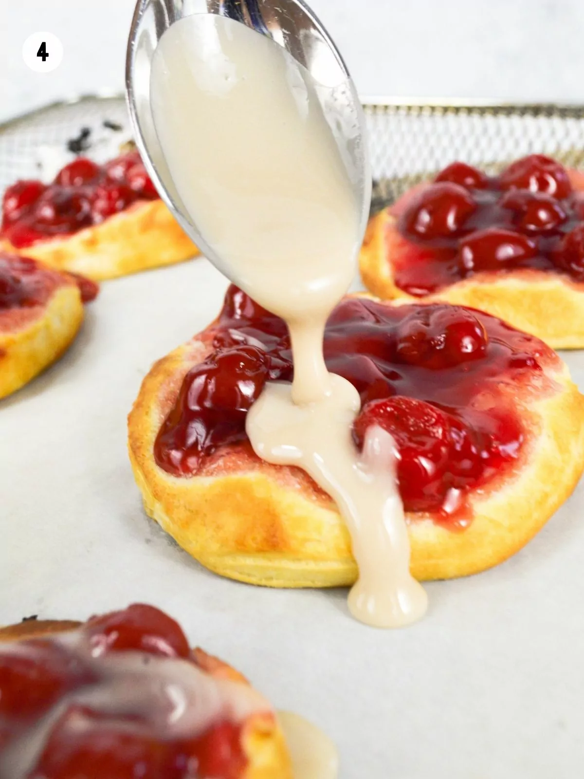 pour glaze on cherry biscuits.