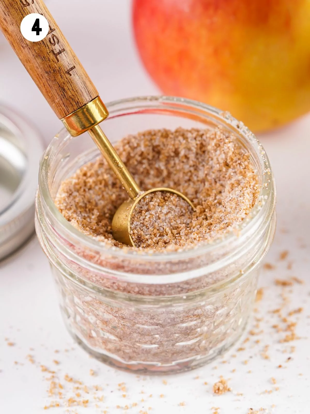 small measuring spoon in 4 ounce mason jar of cider dry mix.