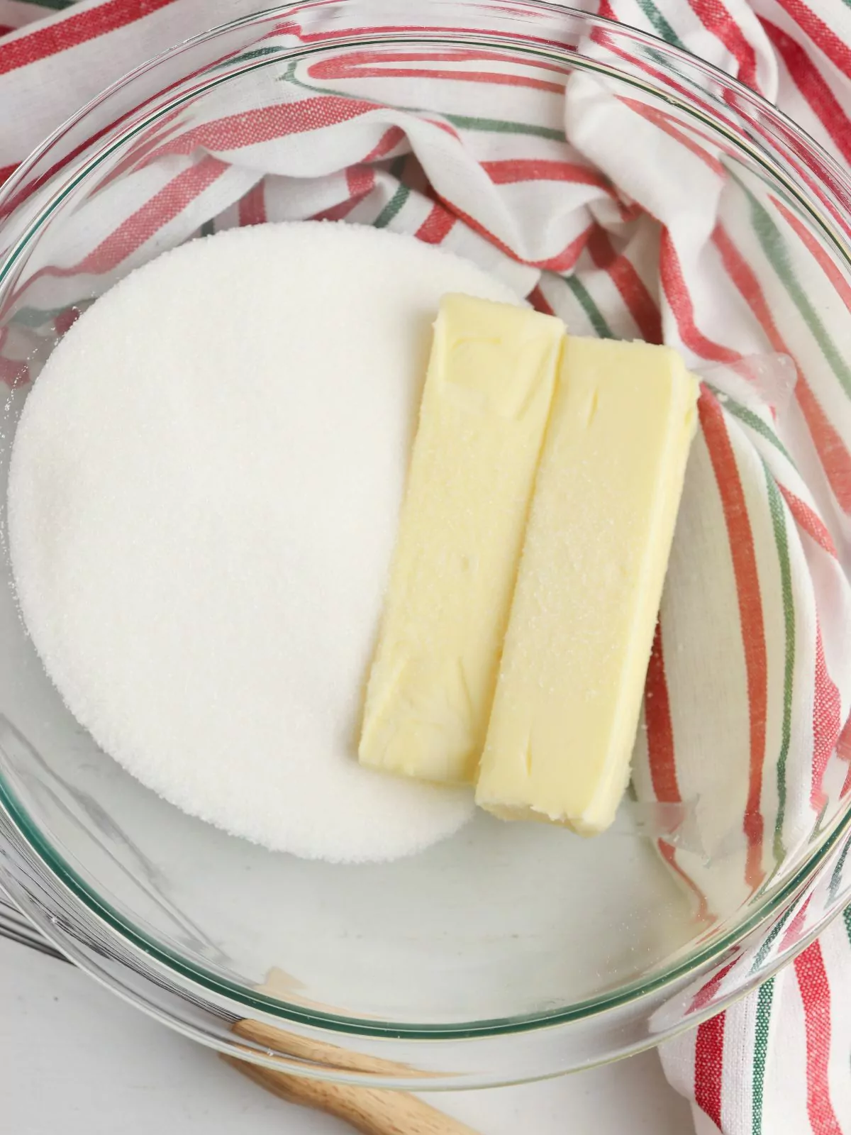 2 sticks of butter with sugar in clear bowl.