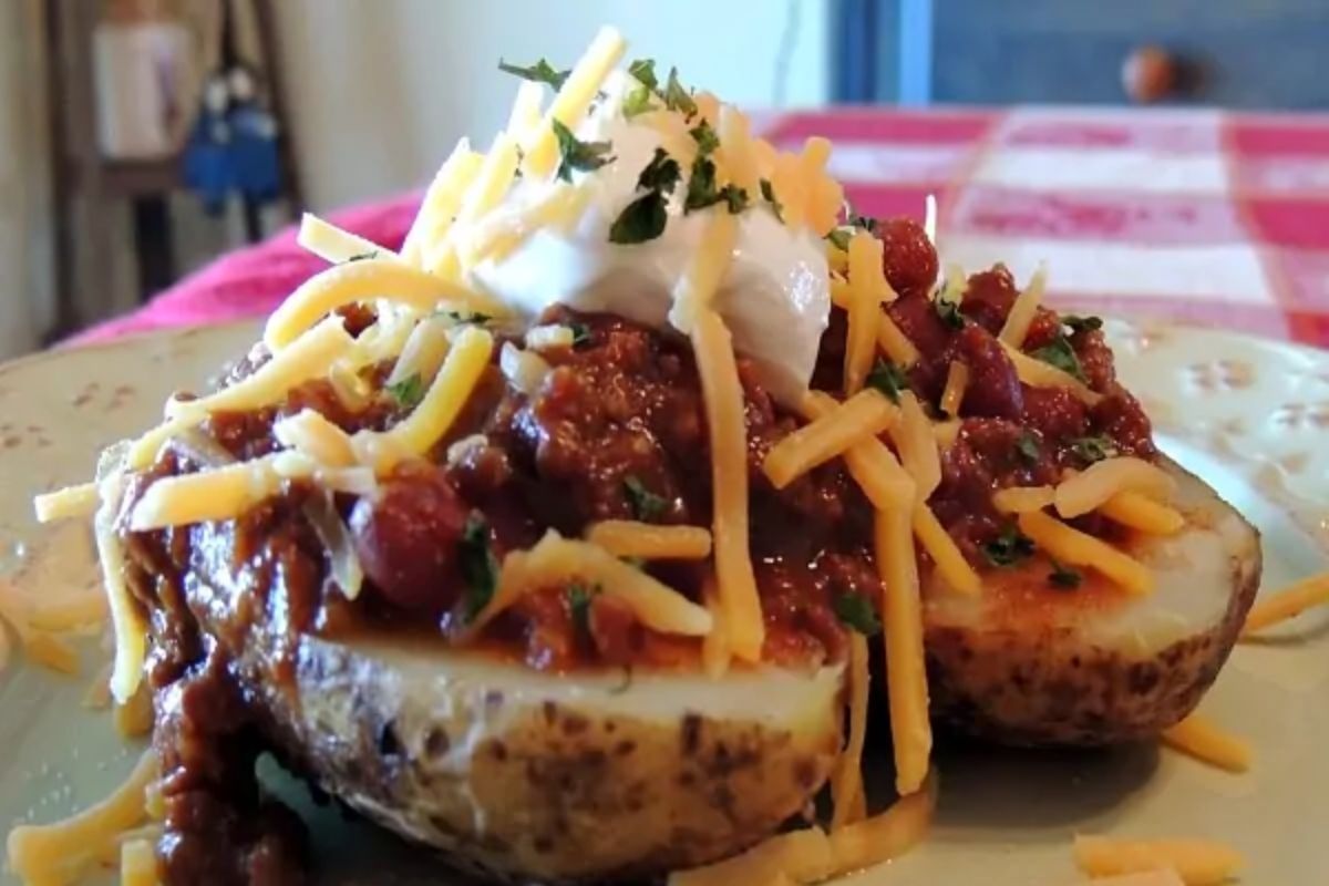 baked potato with leftover chili, cheese and sour cream on top.