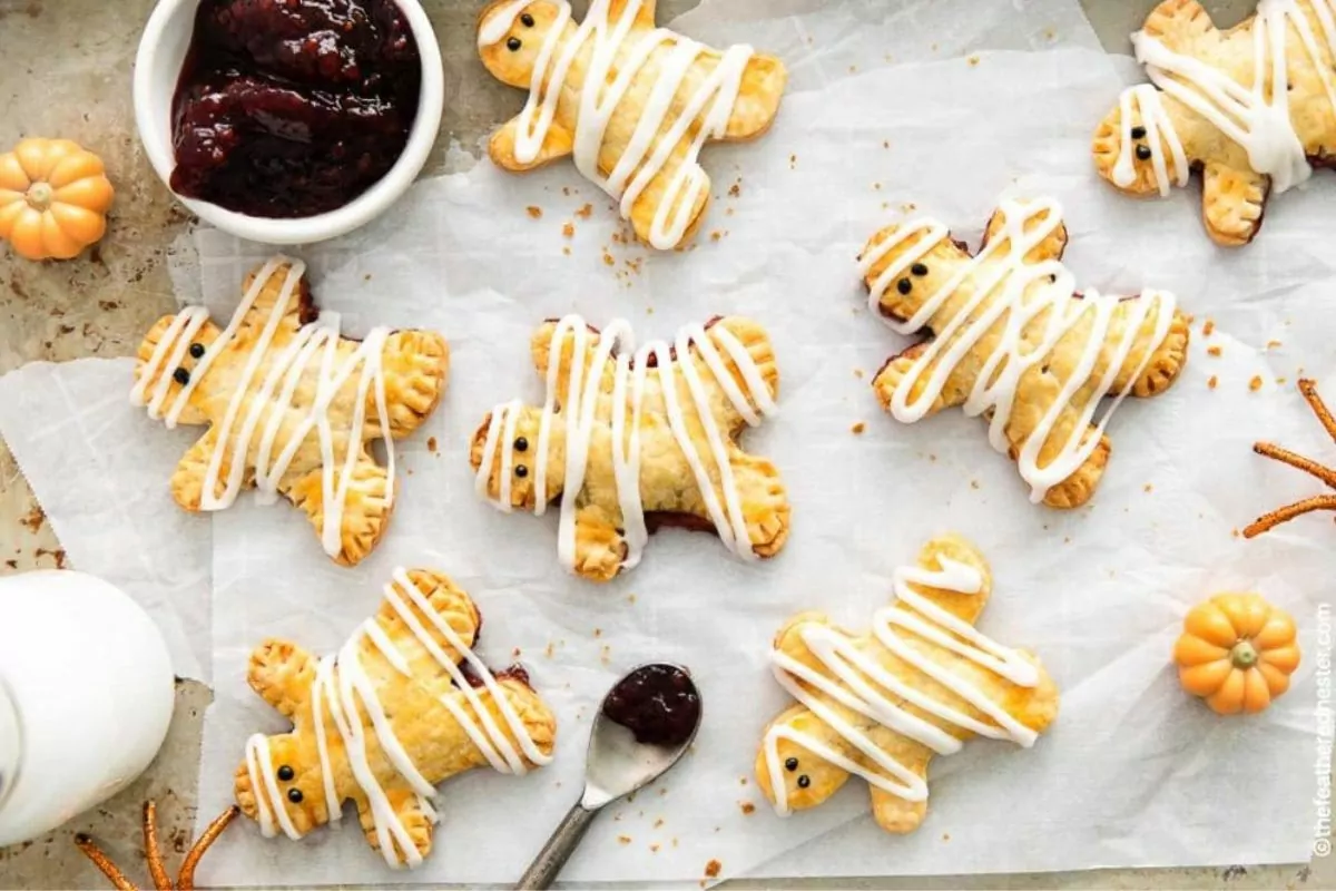 Mummy hand pies on parchment paper.