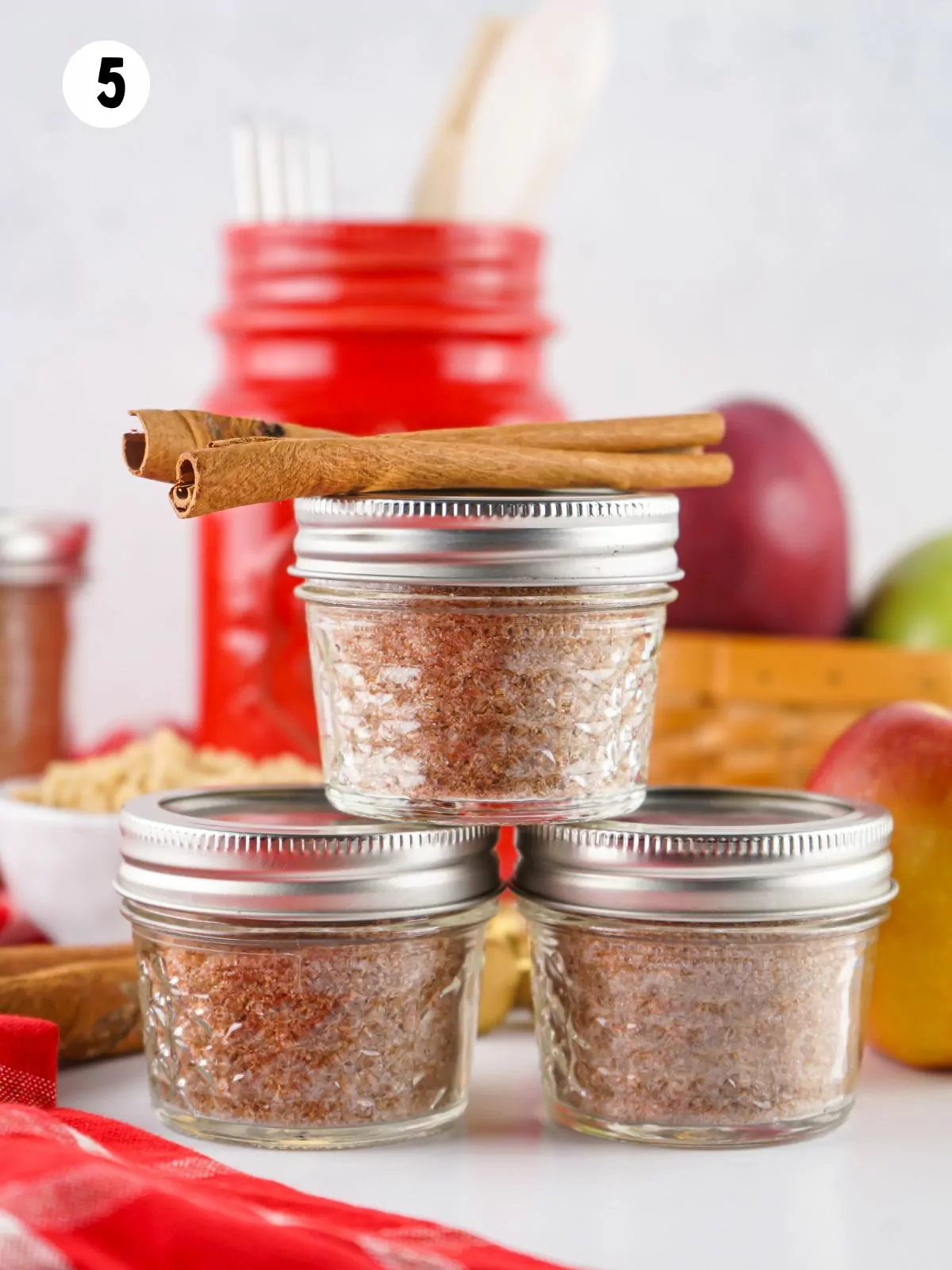 cider mix in small mason jars with cinnamon sticks.