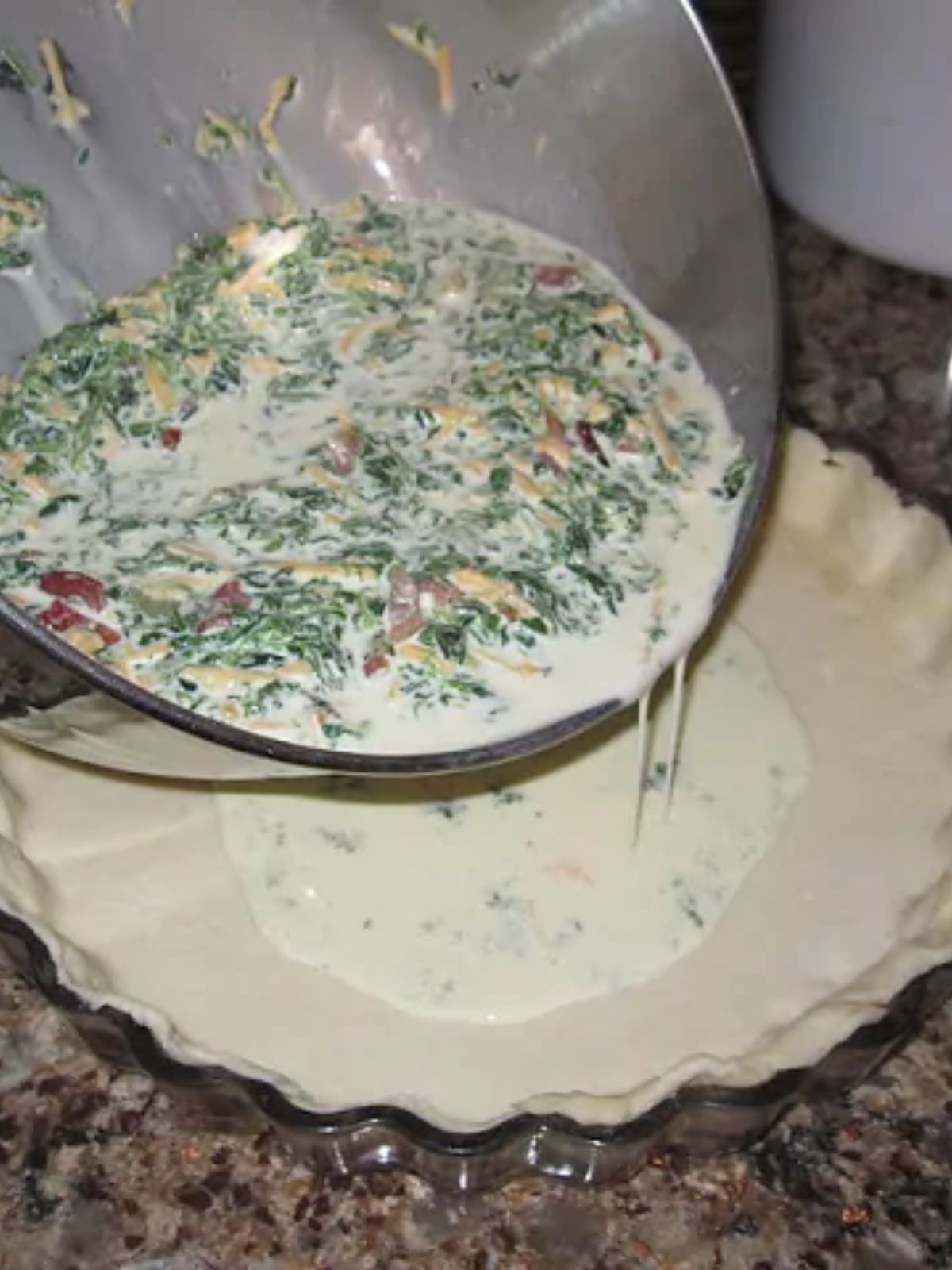 pour quiche into pie crust.