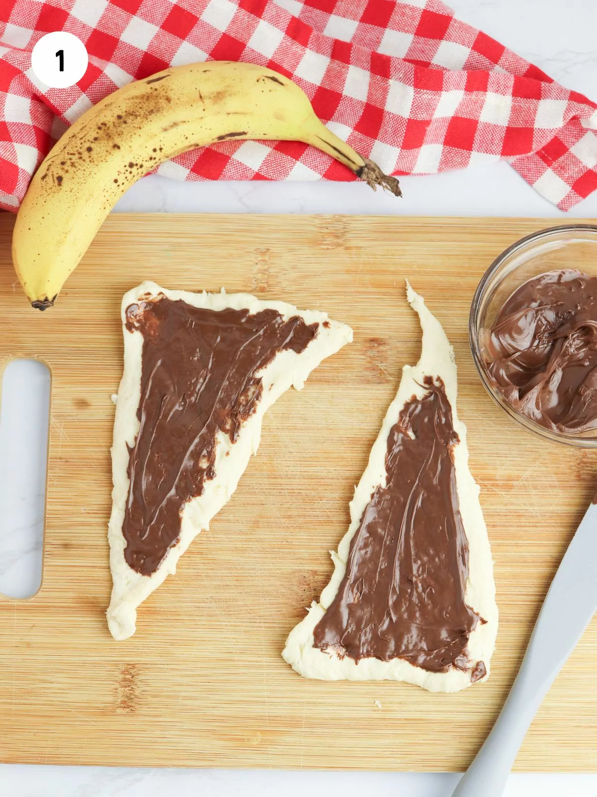 two crescent triangles with nutella spread on them