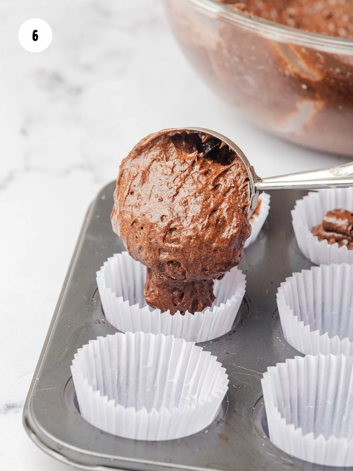 Batter scooped into cupcake liners