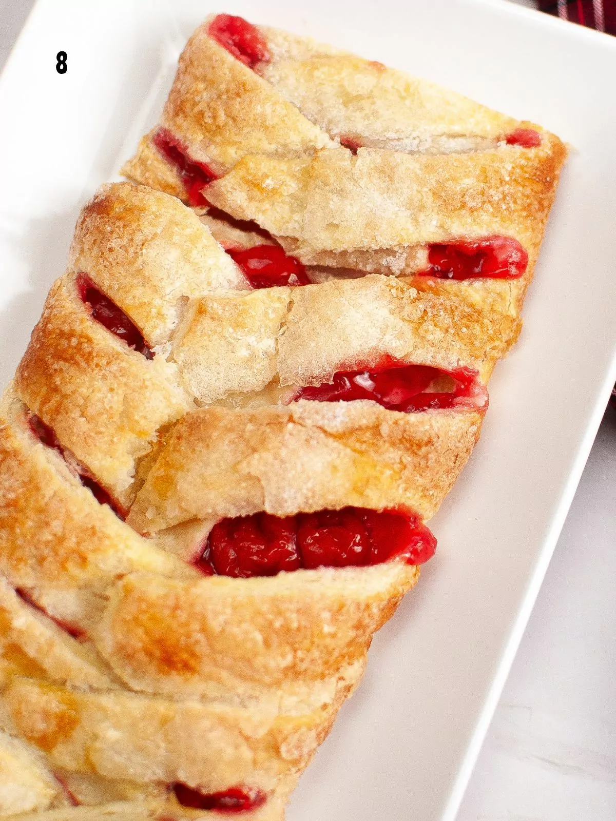 Close up of the baked cherry puff pastry danish