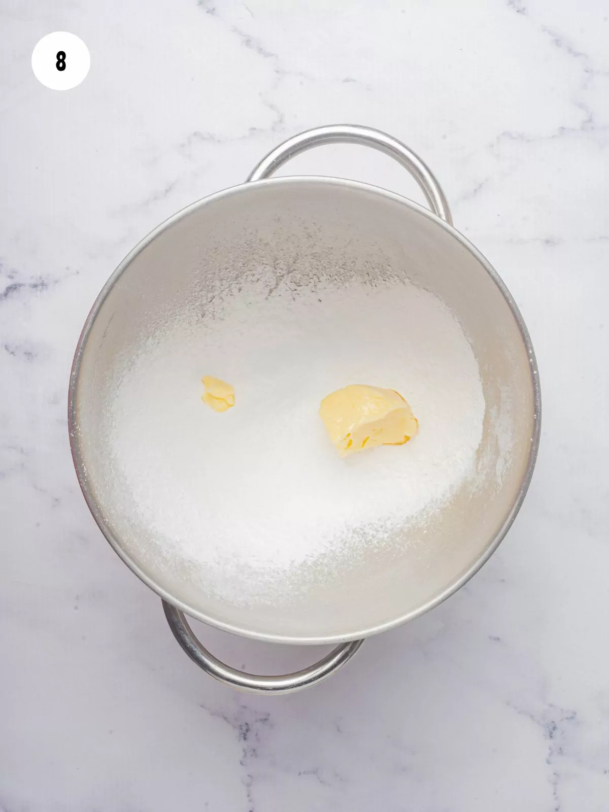 powdered sugar and butter in a mixing bowl