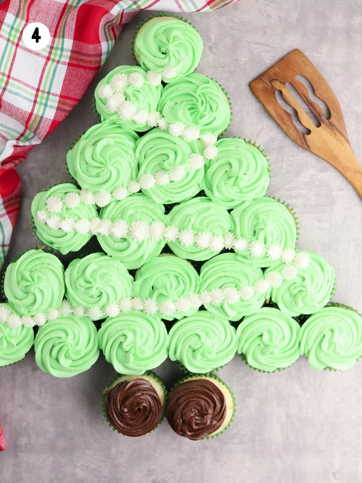 green frosted cupcakes with white frosted design to form a garland.