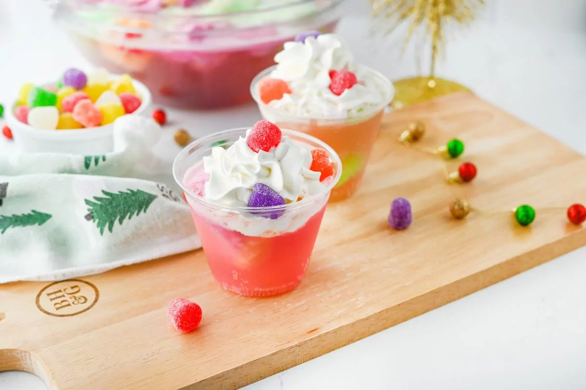 cups of punch with whipped topping and colorful gumdrops