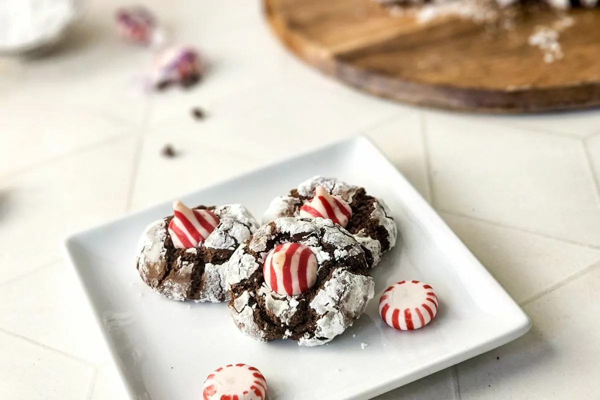 3 peppermint kiss cookies on white plate.