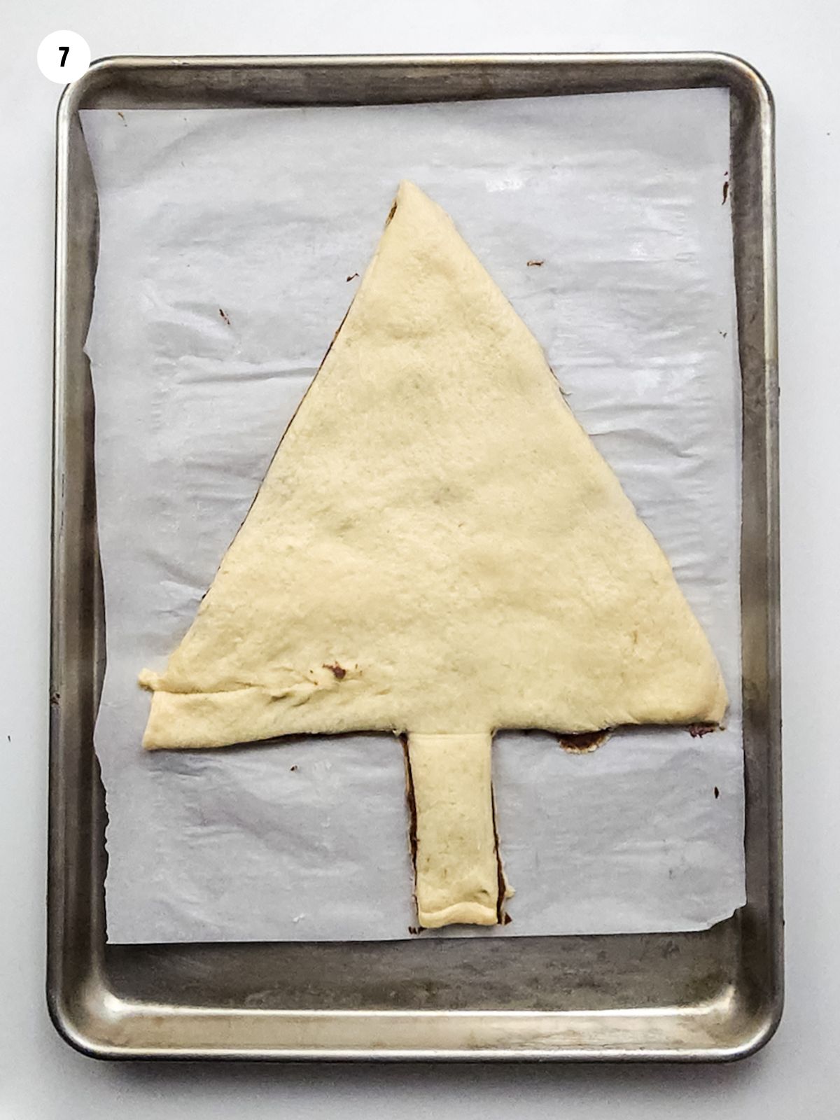 crescent roll sheet dough in the shape of a Christmas tree.