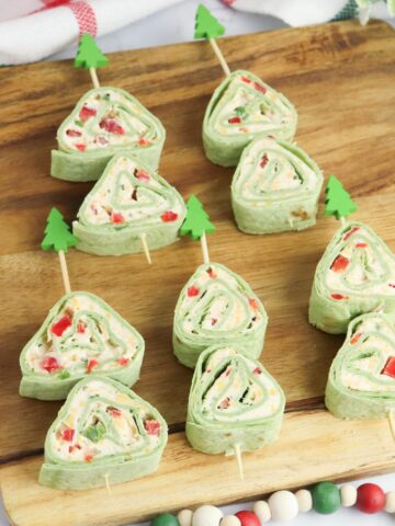 Christmas Tree Pinwheel Appetizers on a wood board