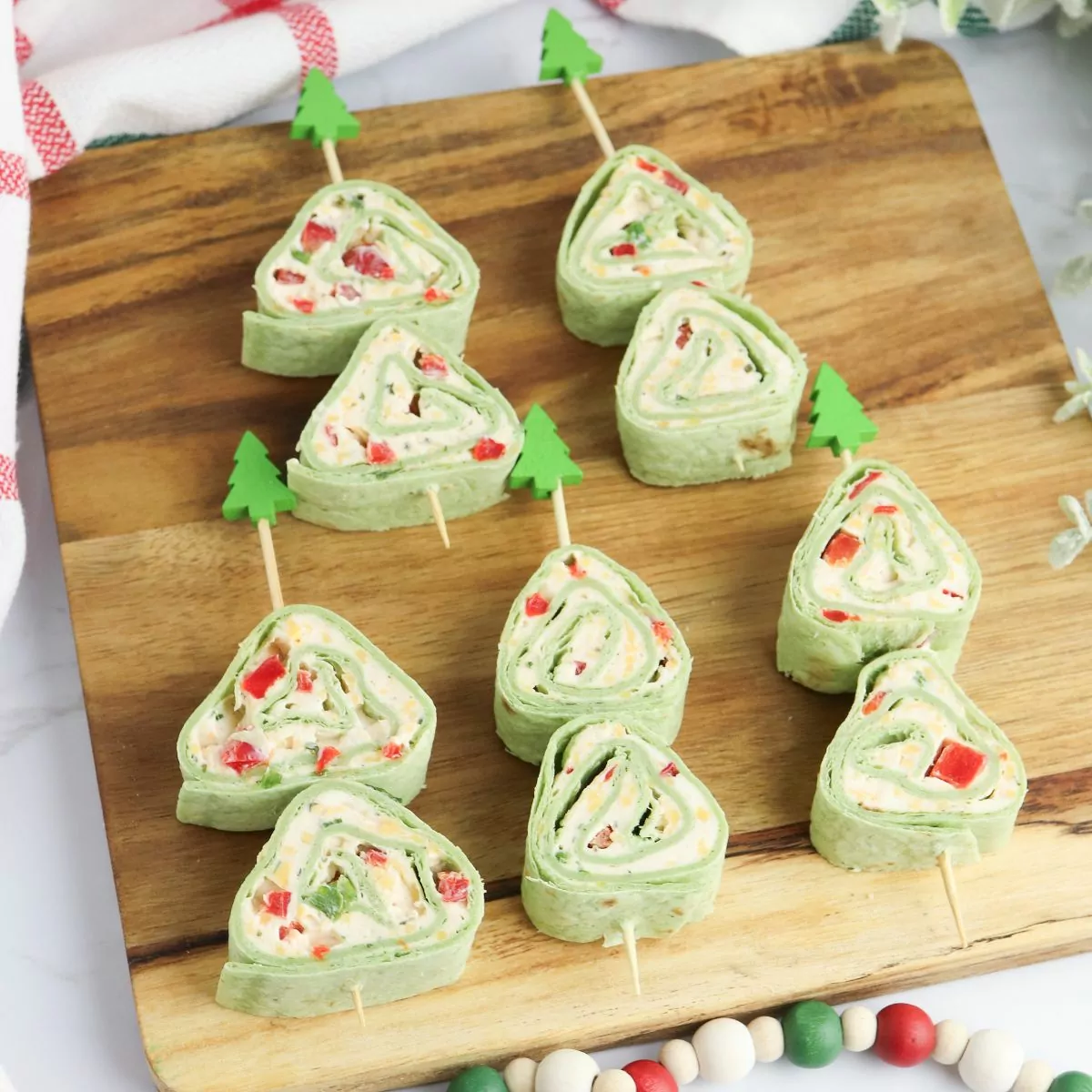 Christmas Tree Pinwheel Appetizers on a wood board