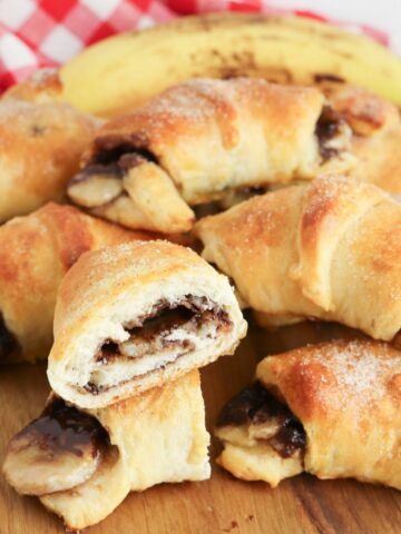 stack of Nutella Banana Crescent Rolls with one showing the inside of it