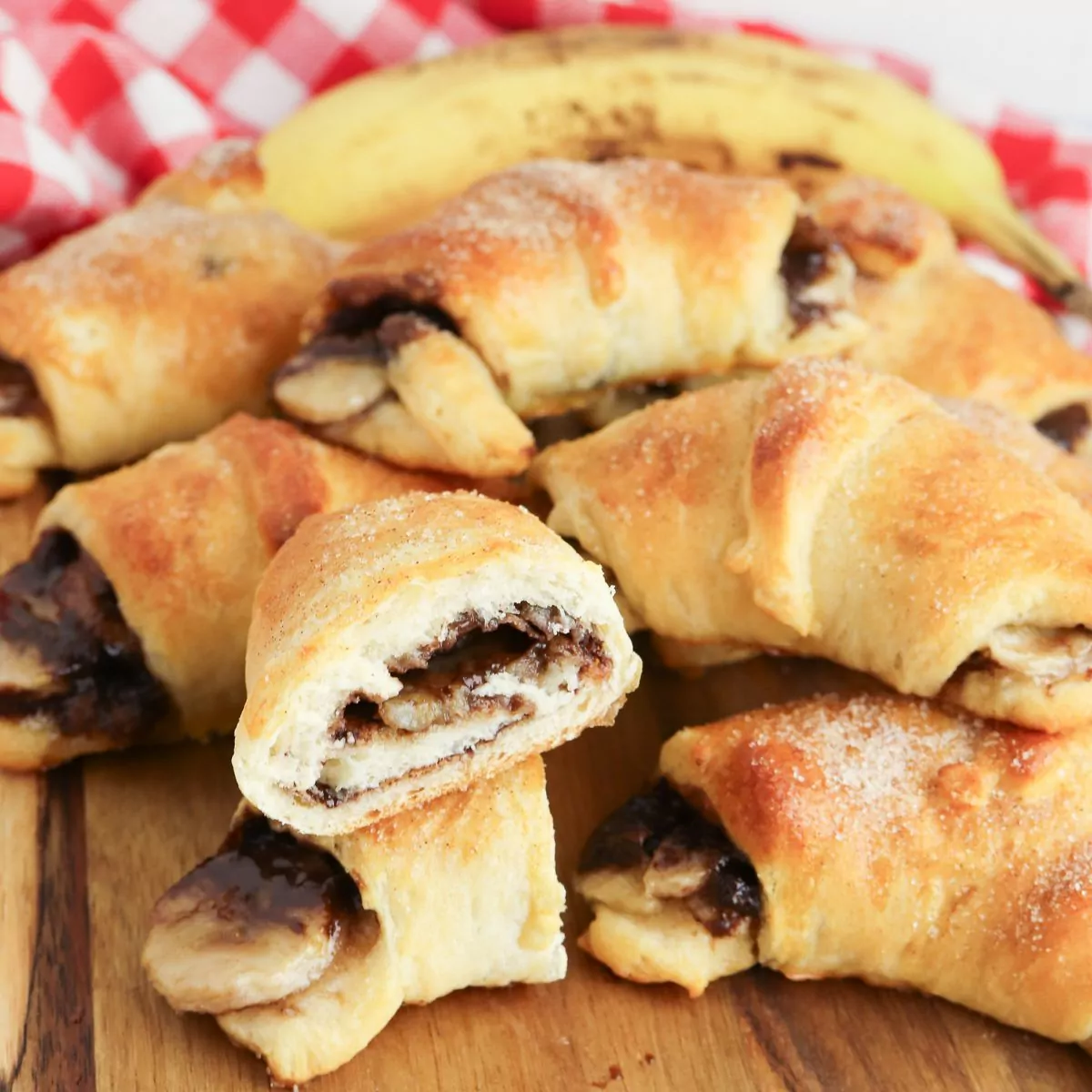 stack of Nutella Banana Crescent Rolls with one showing the inside of it