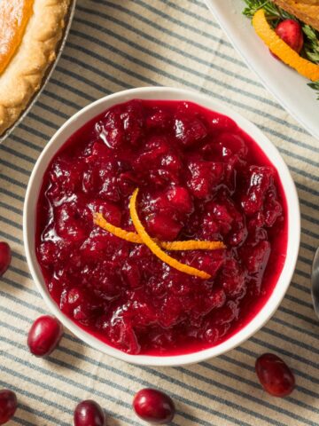 small bowl of cranberry sauce on Thanksgiving table.