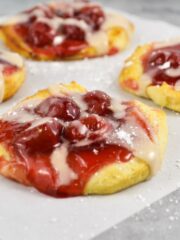 close up of refrigerated biscuit dough with pie filling and glaze.