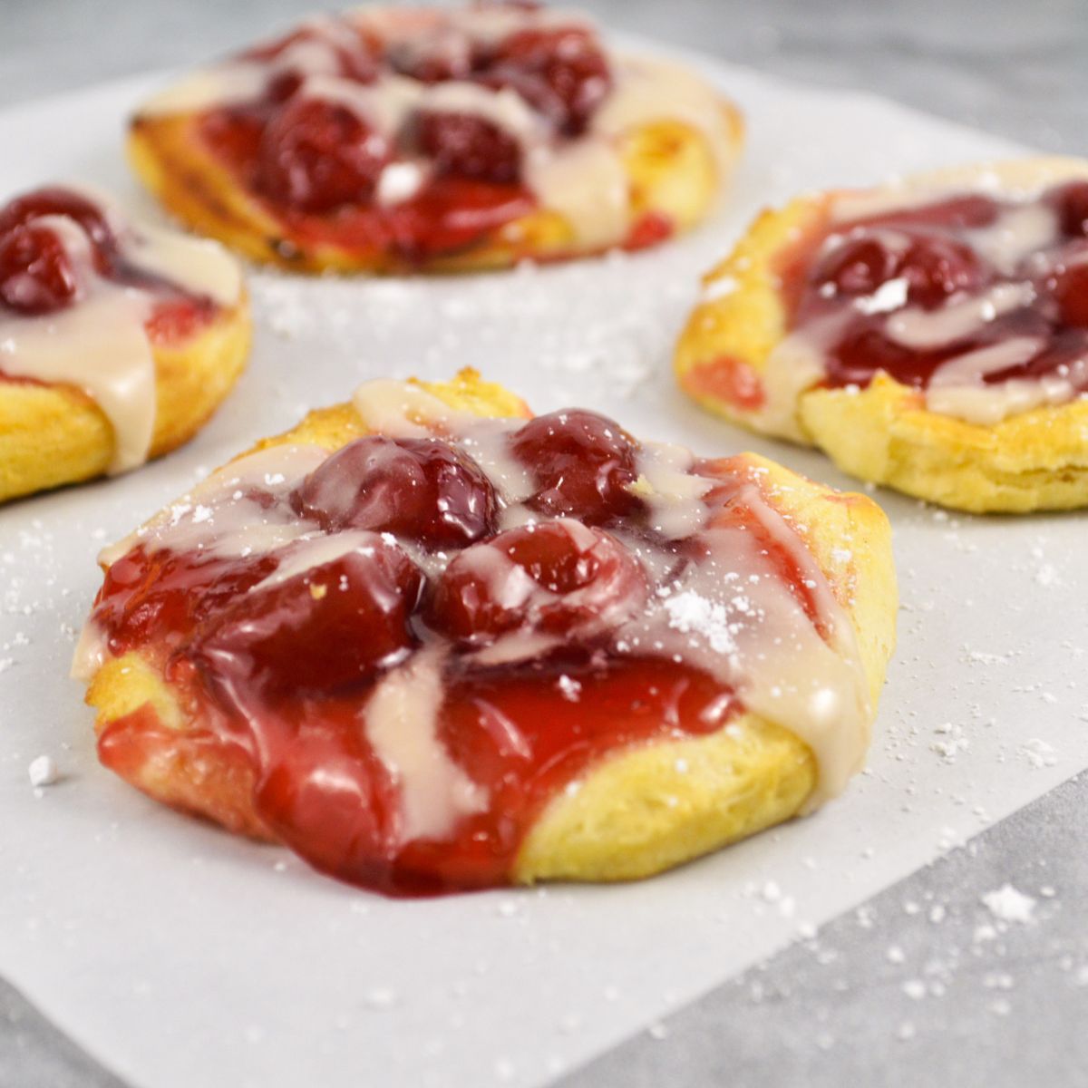 close up of refrigerated biscuit dough with pie filling and glaze.