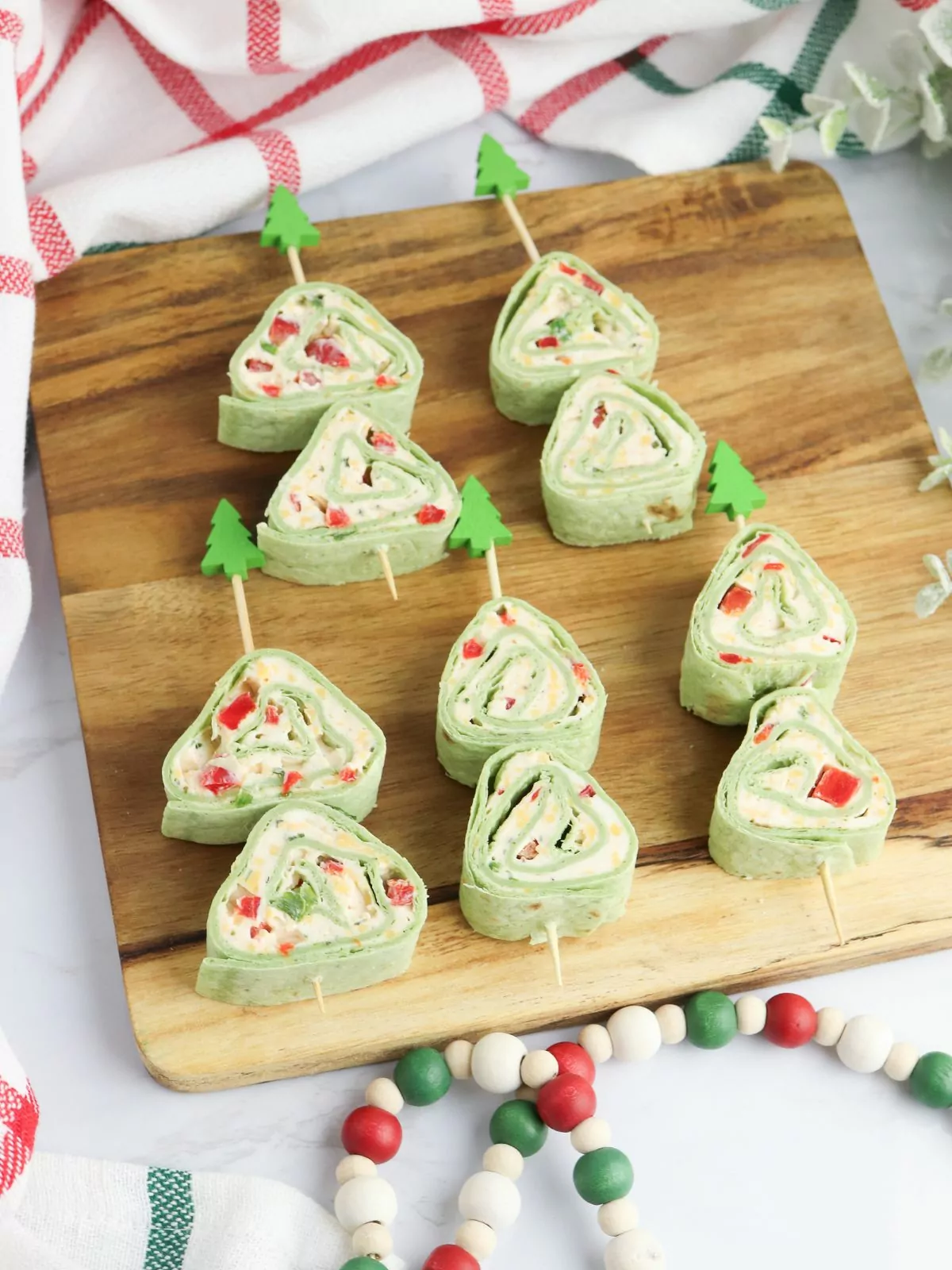 five Christmas Tree Appetizers on a wood board