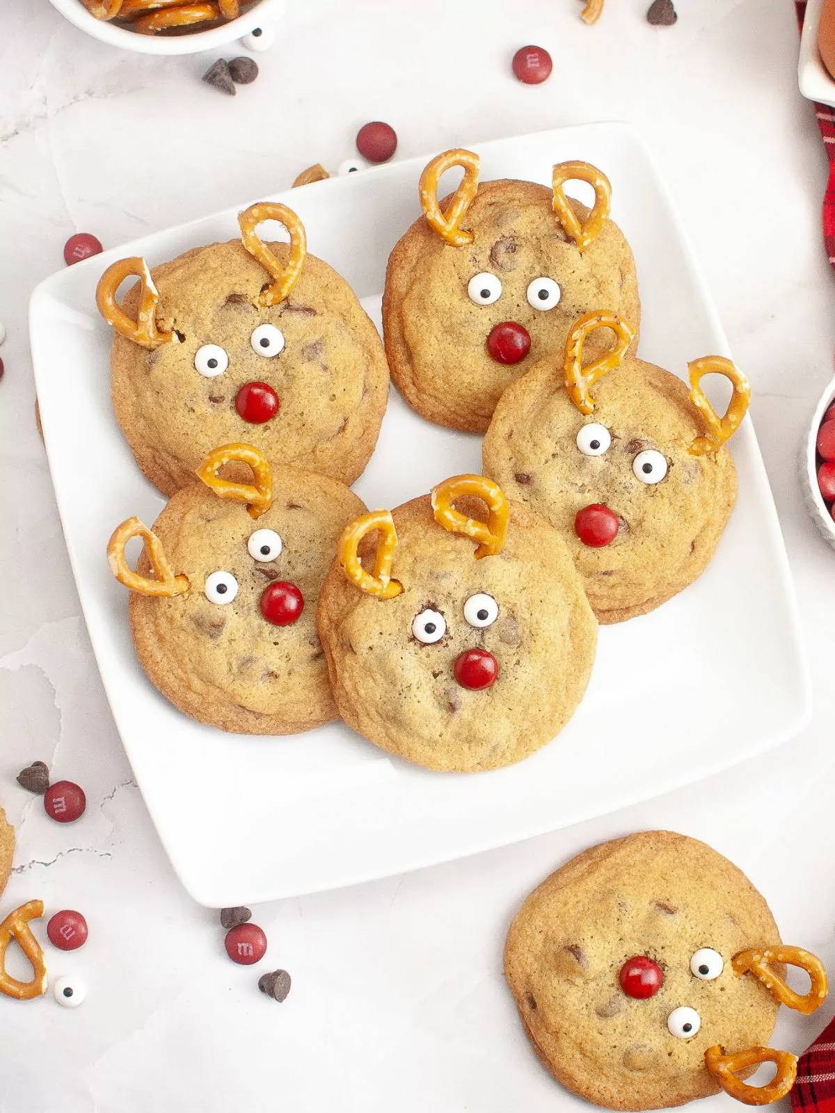 Reindeer Chocolate Chip Cookies with pretzels and candy on a white plate