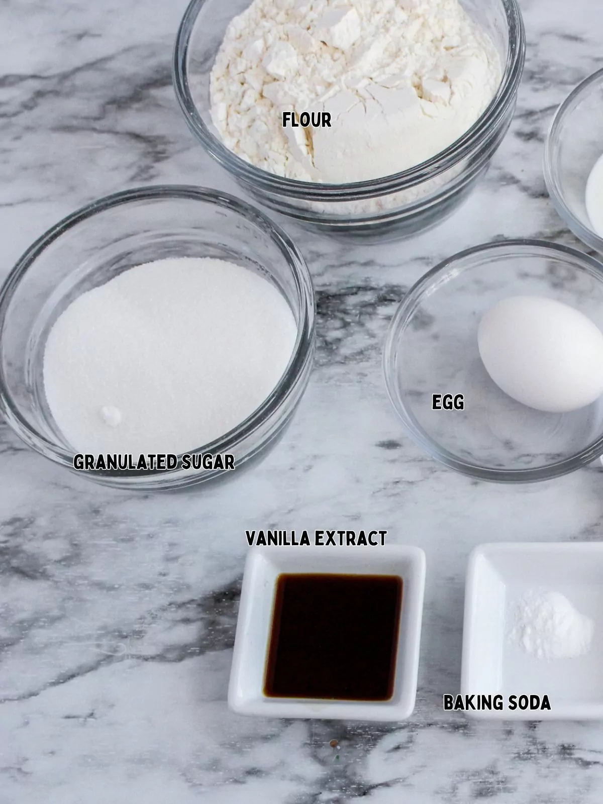 ingredients for cookies in small bowls.