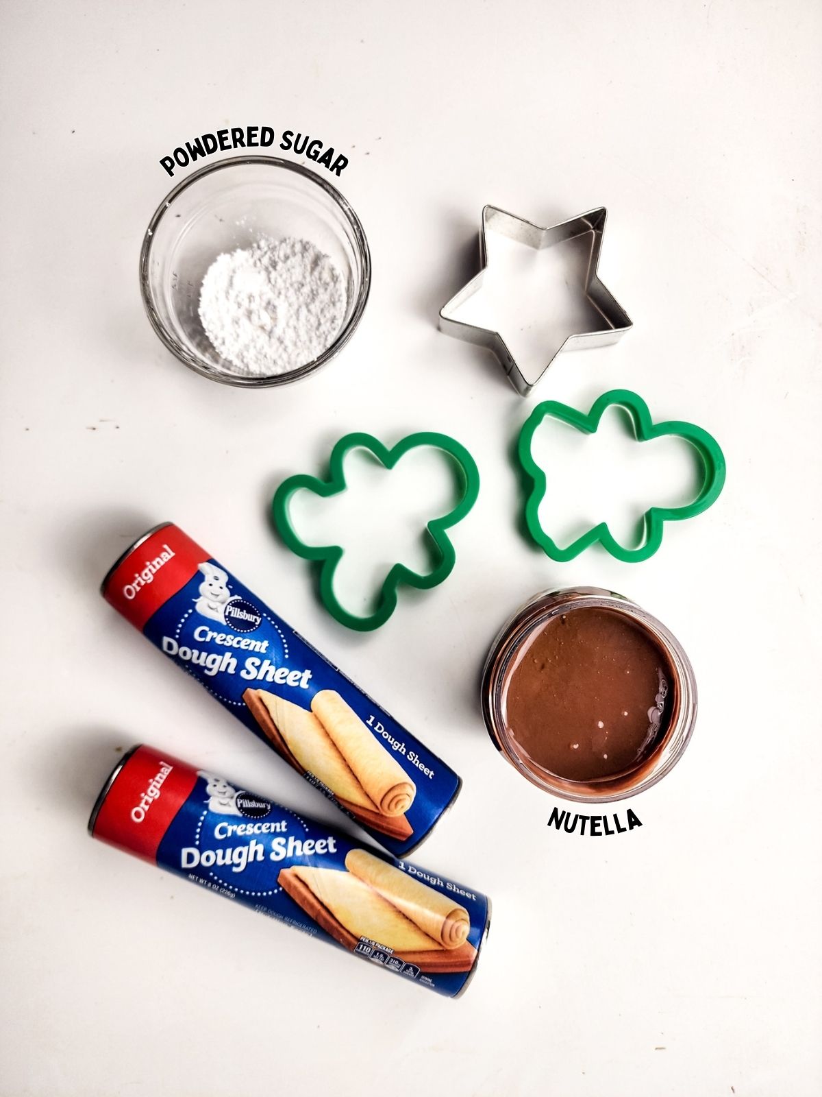ingredients crescent roll sheet dough, Nutella, powdered sugar with cookie cutters.