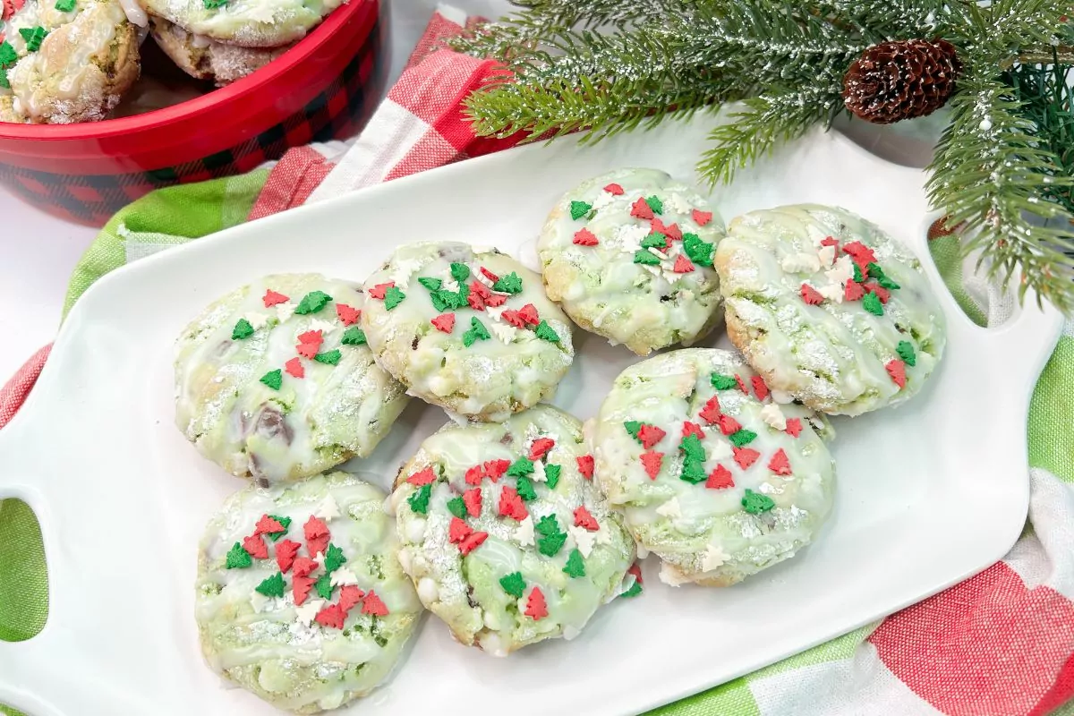 Mint Christmas Cookies with Christmas tree shaped sprinkles on white platter. MSN.