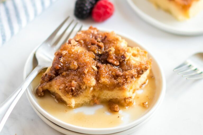 Overnight French Toast Casserole on plate with syrup msn.