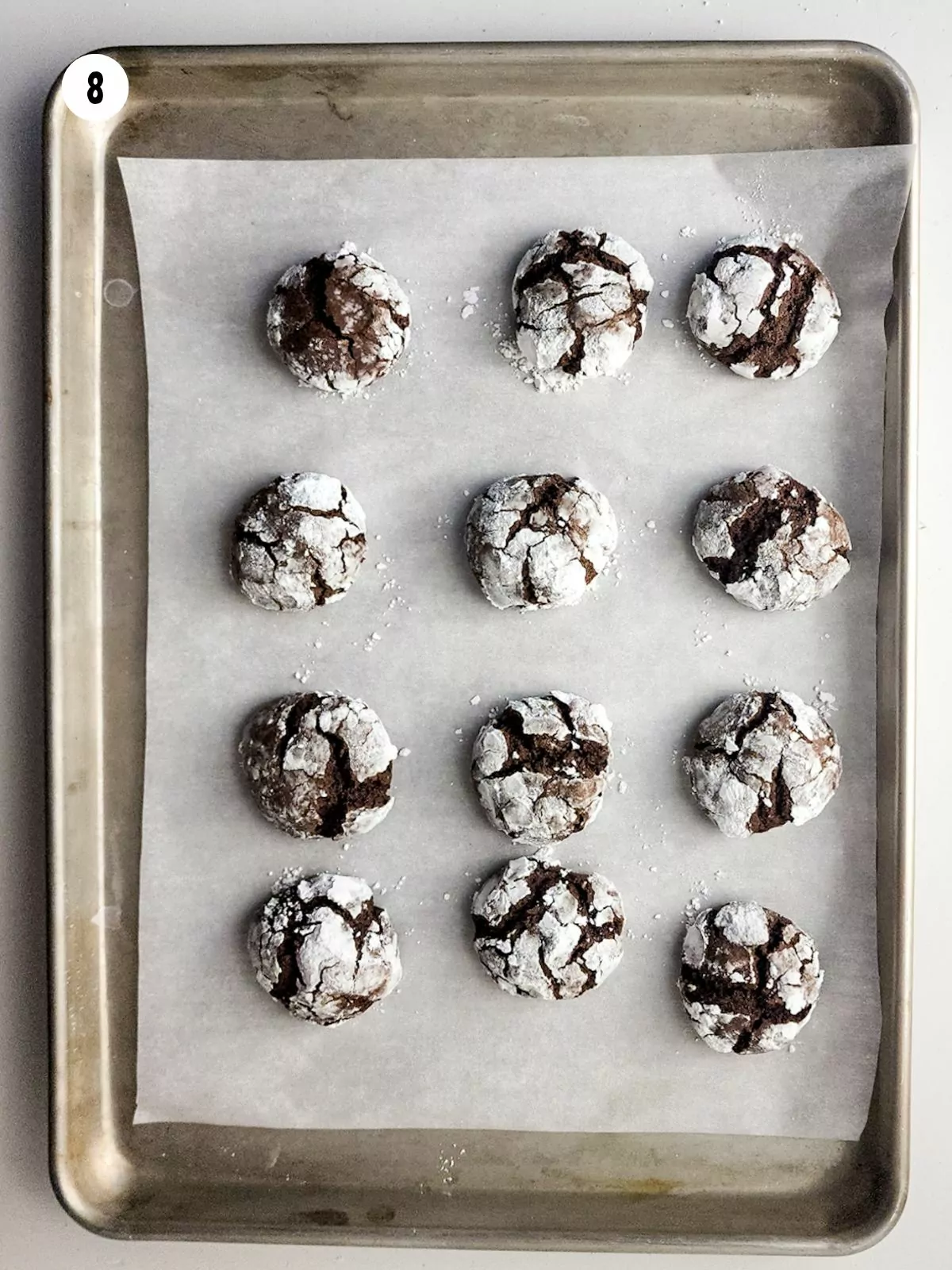 chocolate crinkle thumbprint cookies baked on tray.