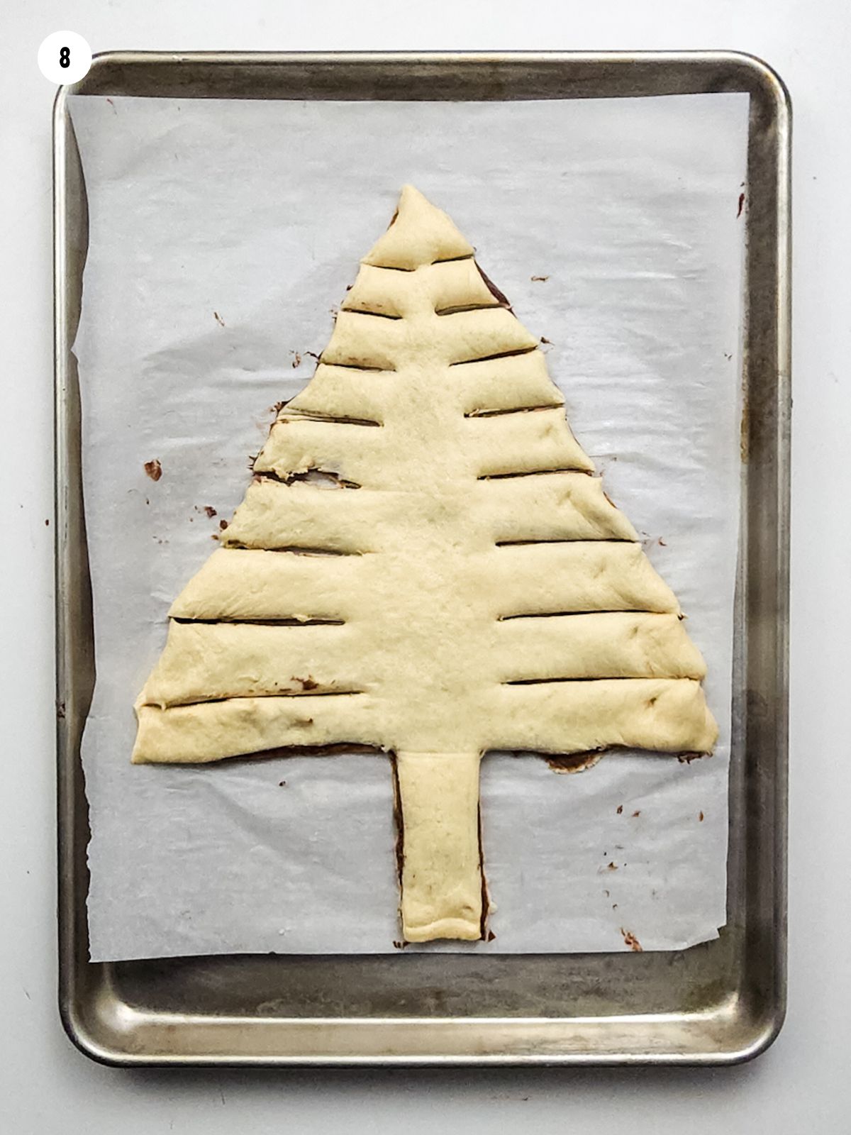 crescent roll sheet dough with hazelnut spread in the shape of a tree.