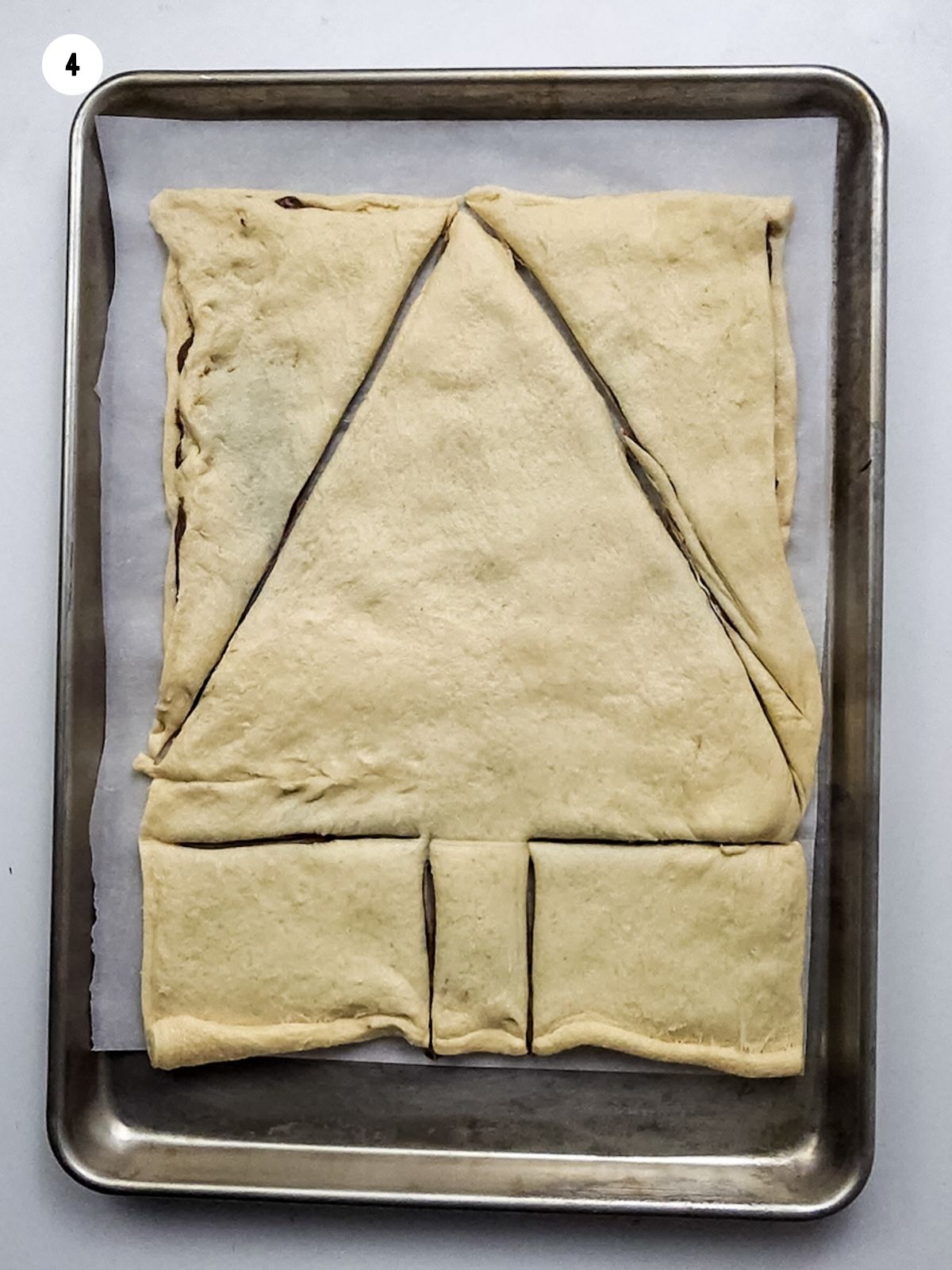 cut out Christmas tree in crescent roll sheet dough.