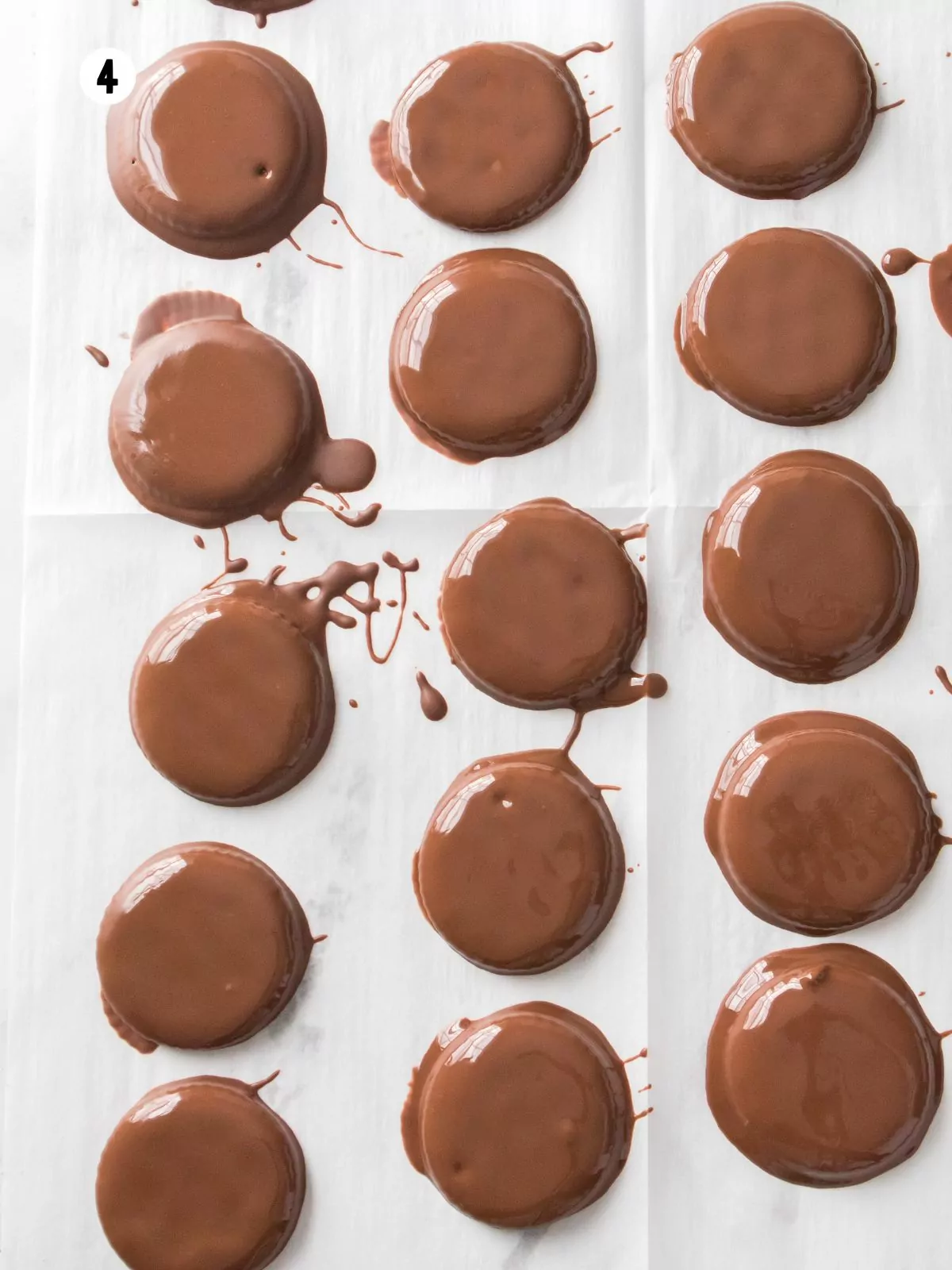 dipped chocolate covered crackers on parchment paper.