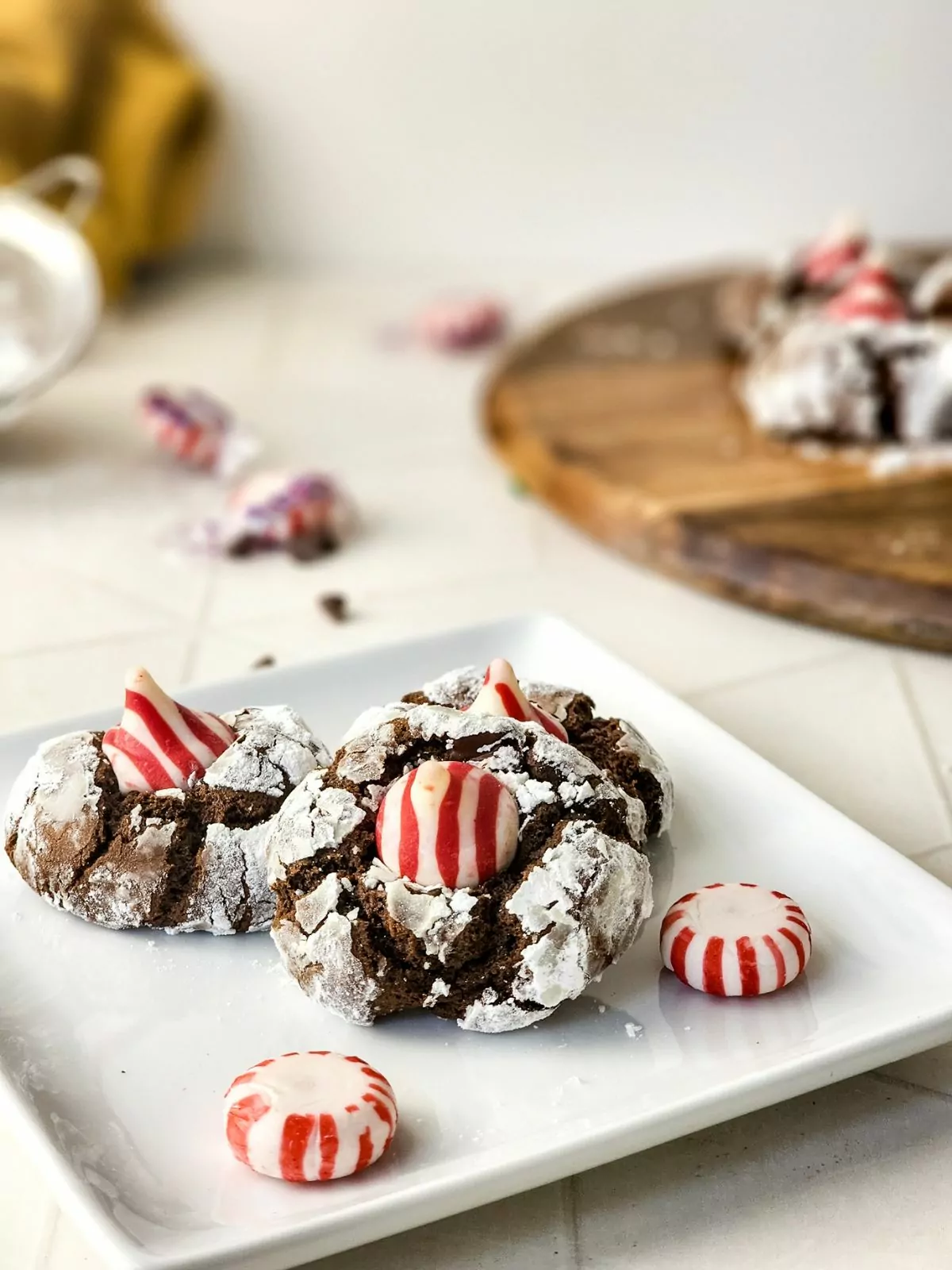 peppermint kiss cookies on white plate with candies.