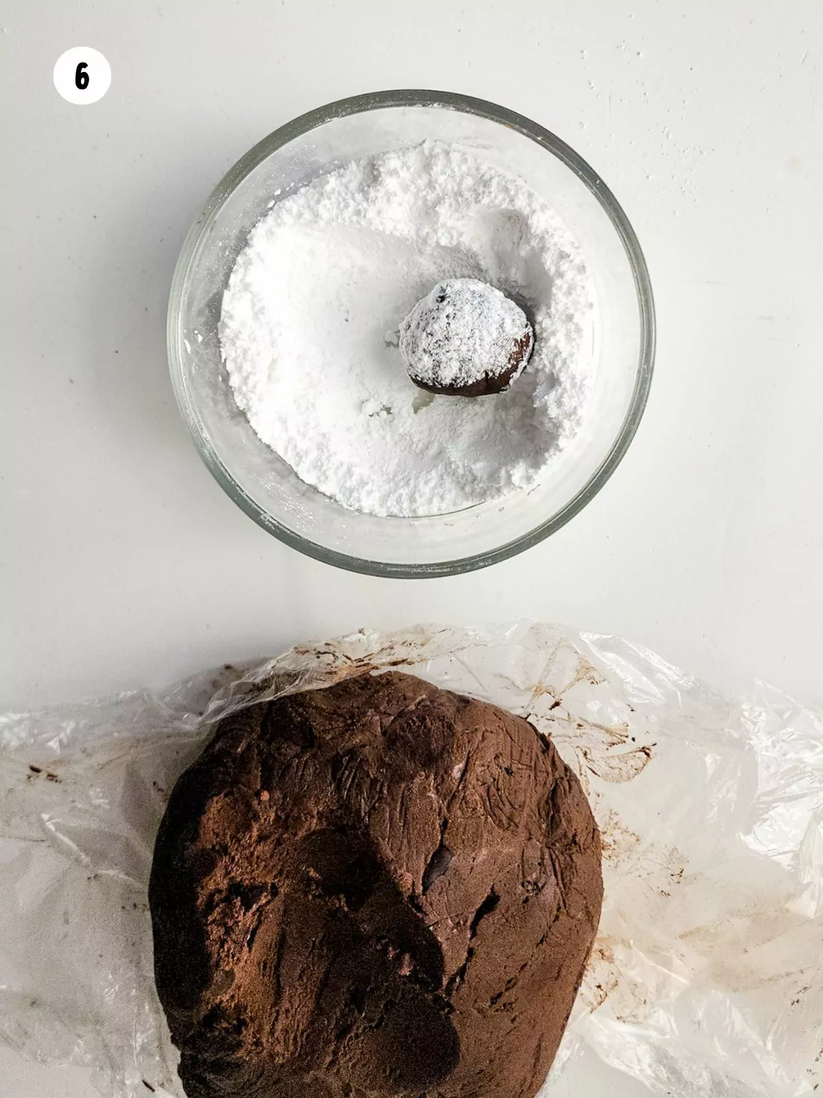 chocolate cookie dough and dough ball in powdered sugar.