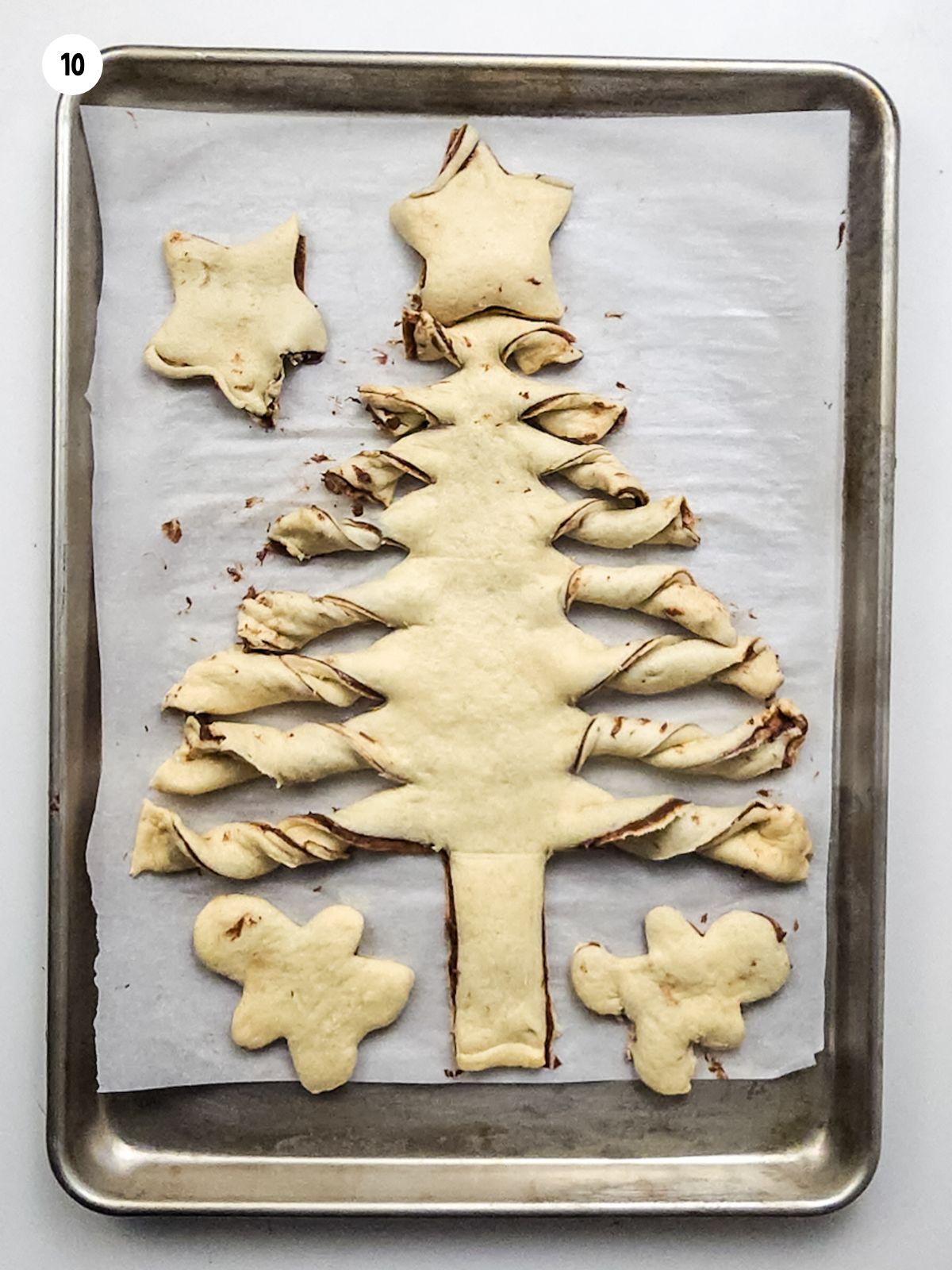 Christmas tree made from crescent rolls on baking tray ready for the oven.