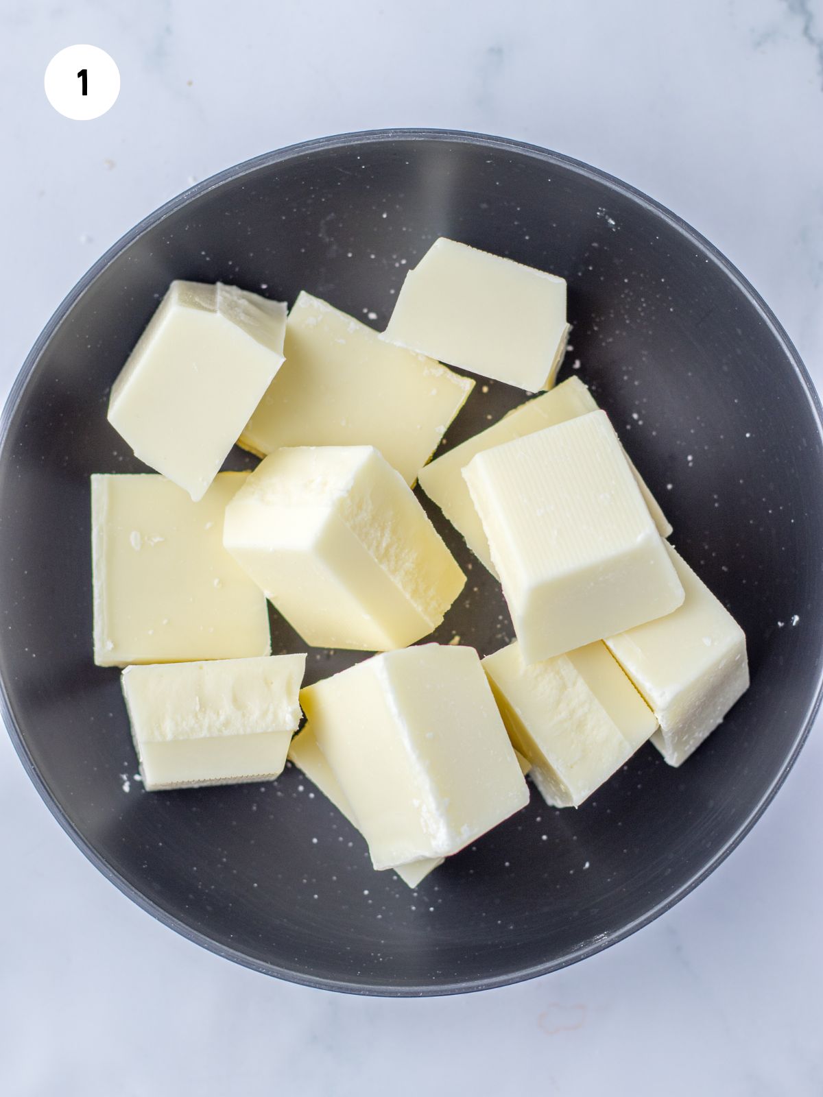 cubes of almond bark in a black bowl