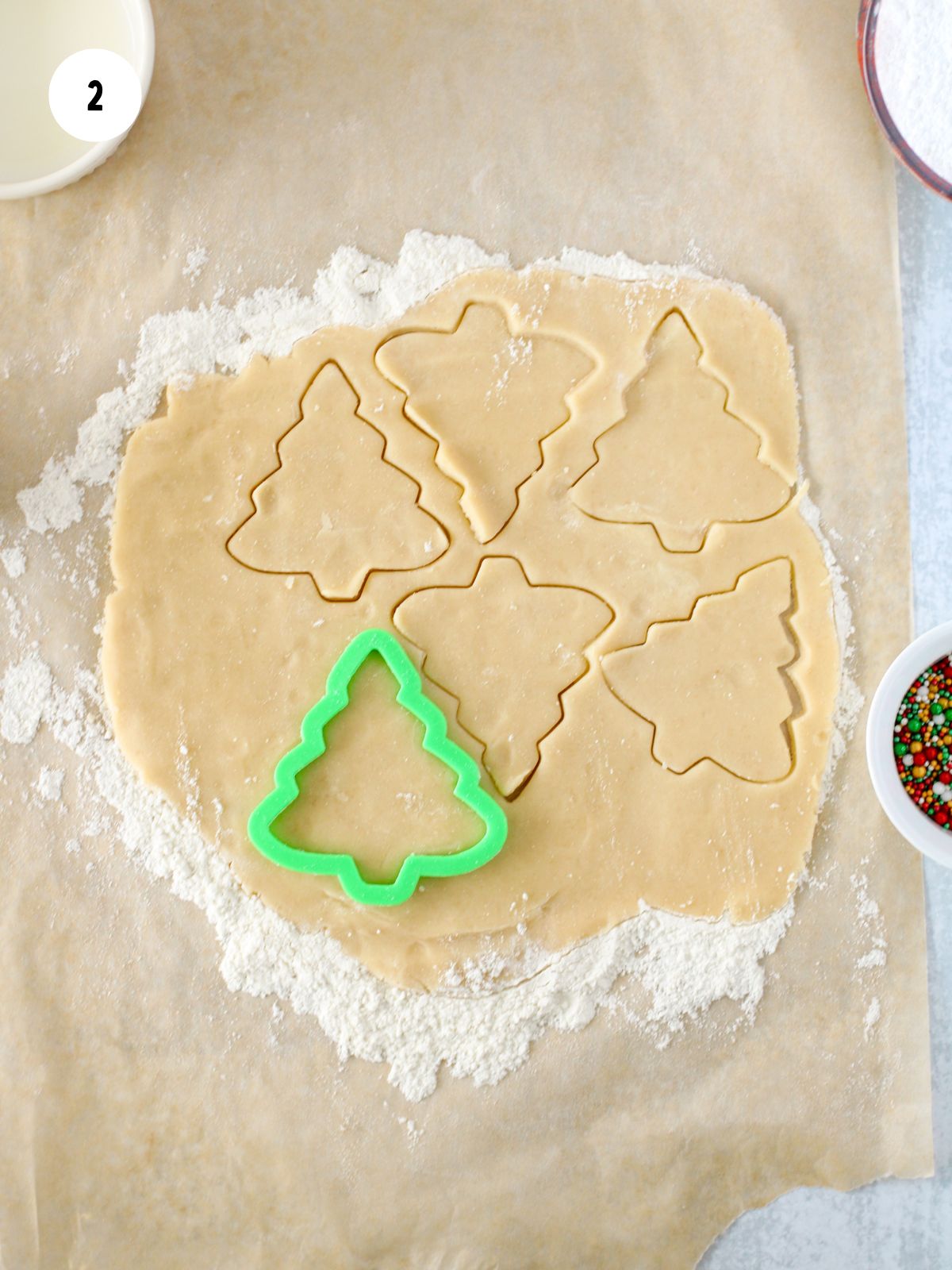 cookie cutter trees cut out of rolled out dough