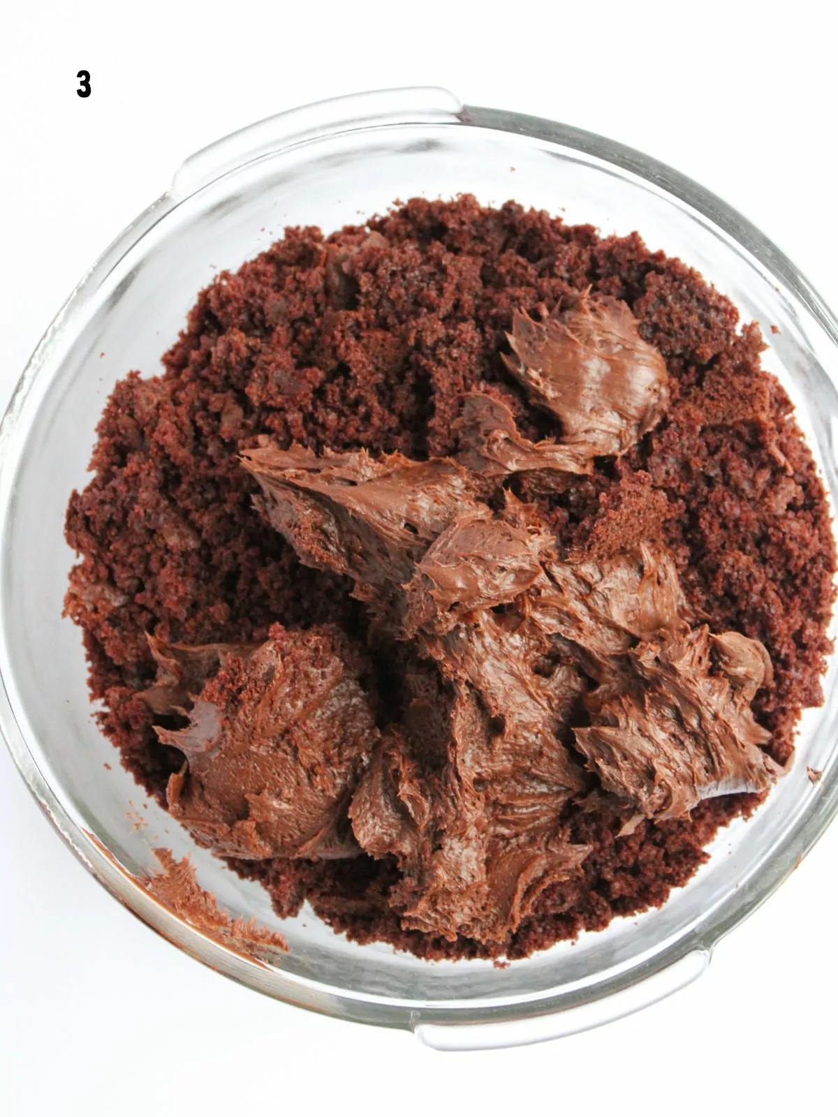 chocolate frosting added to cake crumbs