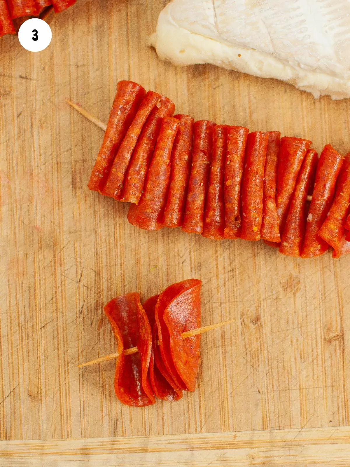 pepperoni ribbon made with folded pepperoni on a toothpick