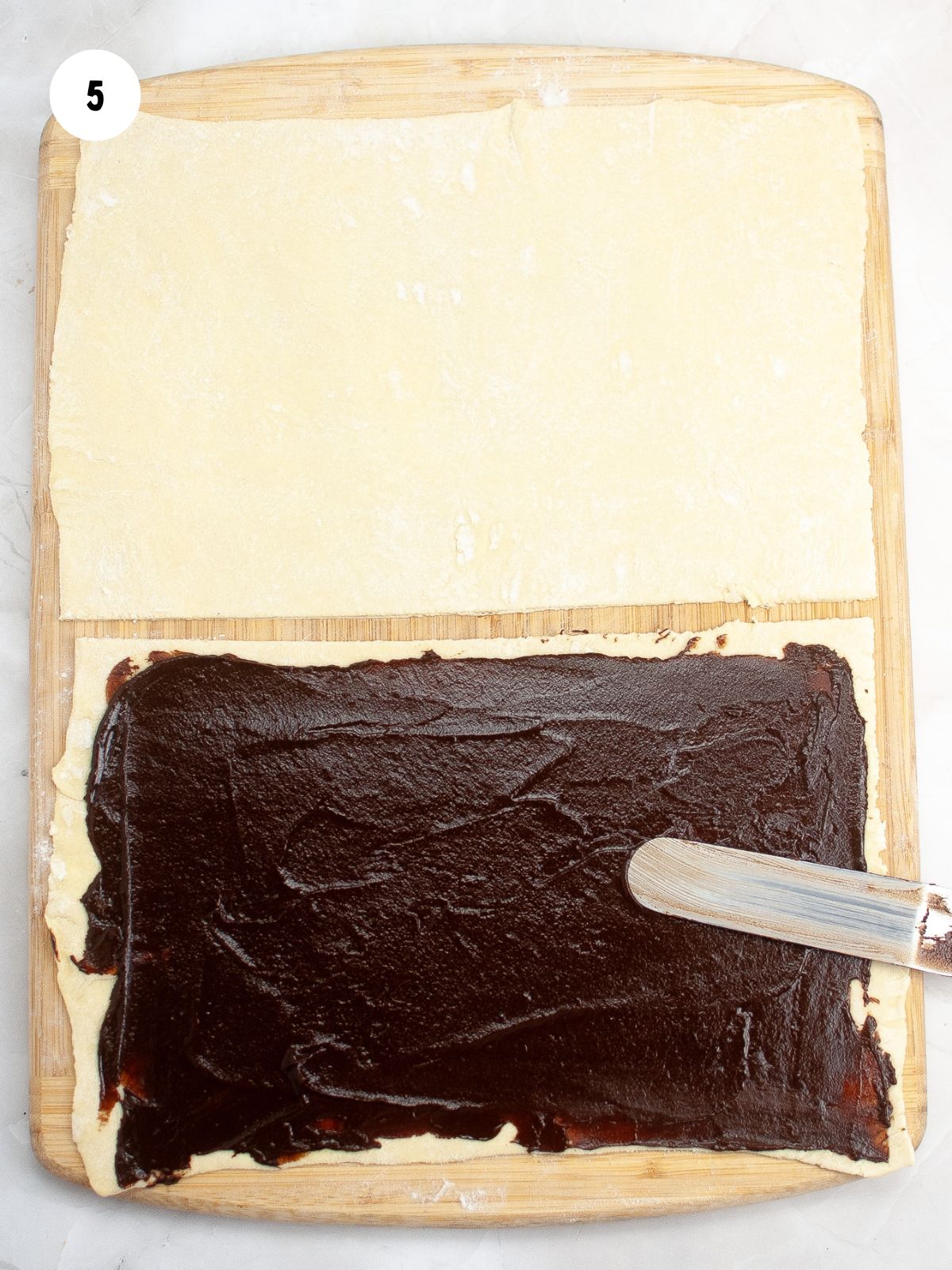 chocolate spread on half of the puff pastry