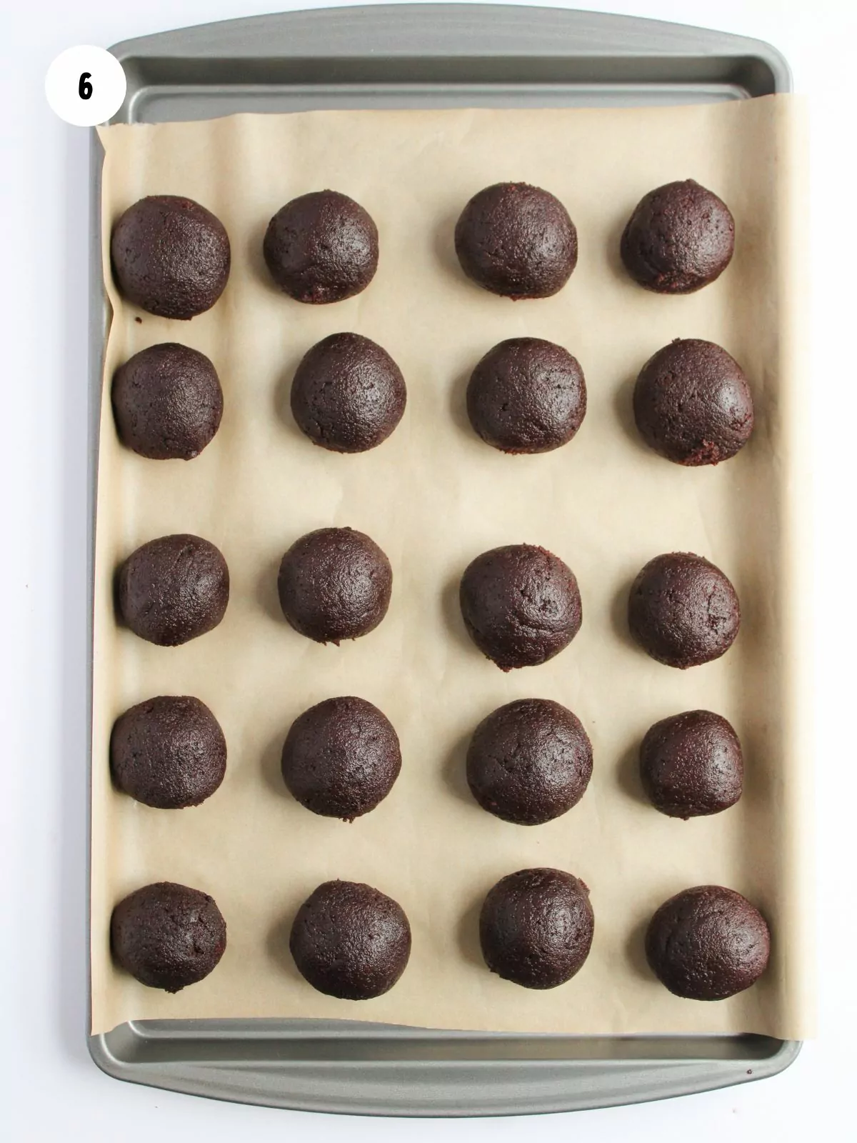 cake balls on a pan lined with parchment paper