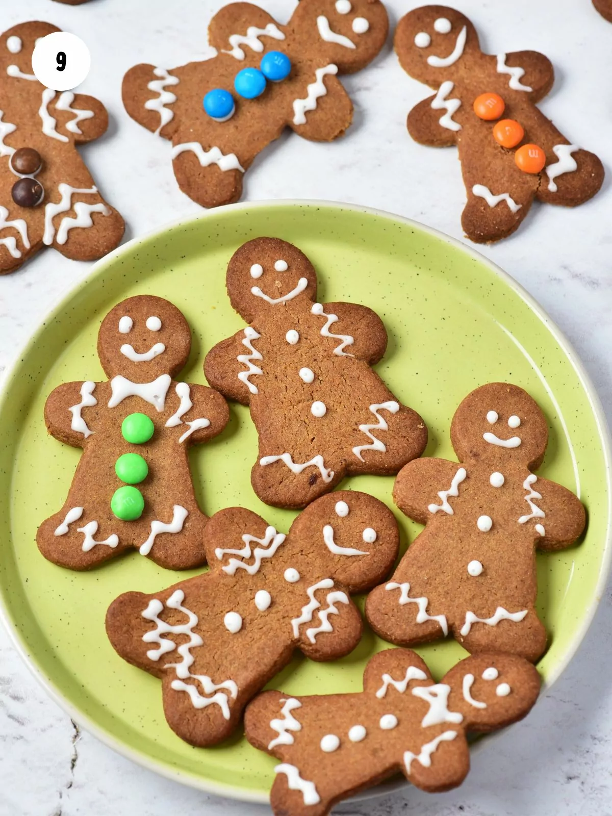 decorated gingerbread man cookies on lime green plate