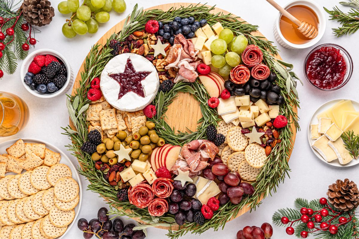 Christmas Wreath Charcuterie Board with ingredients scattered around the board