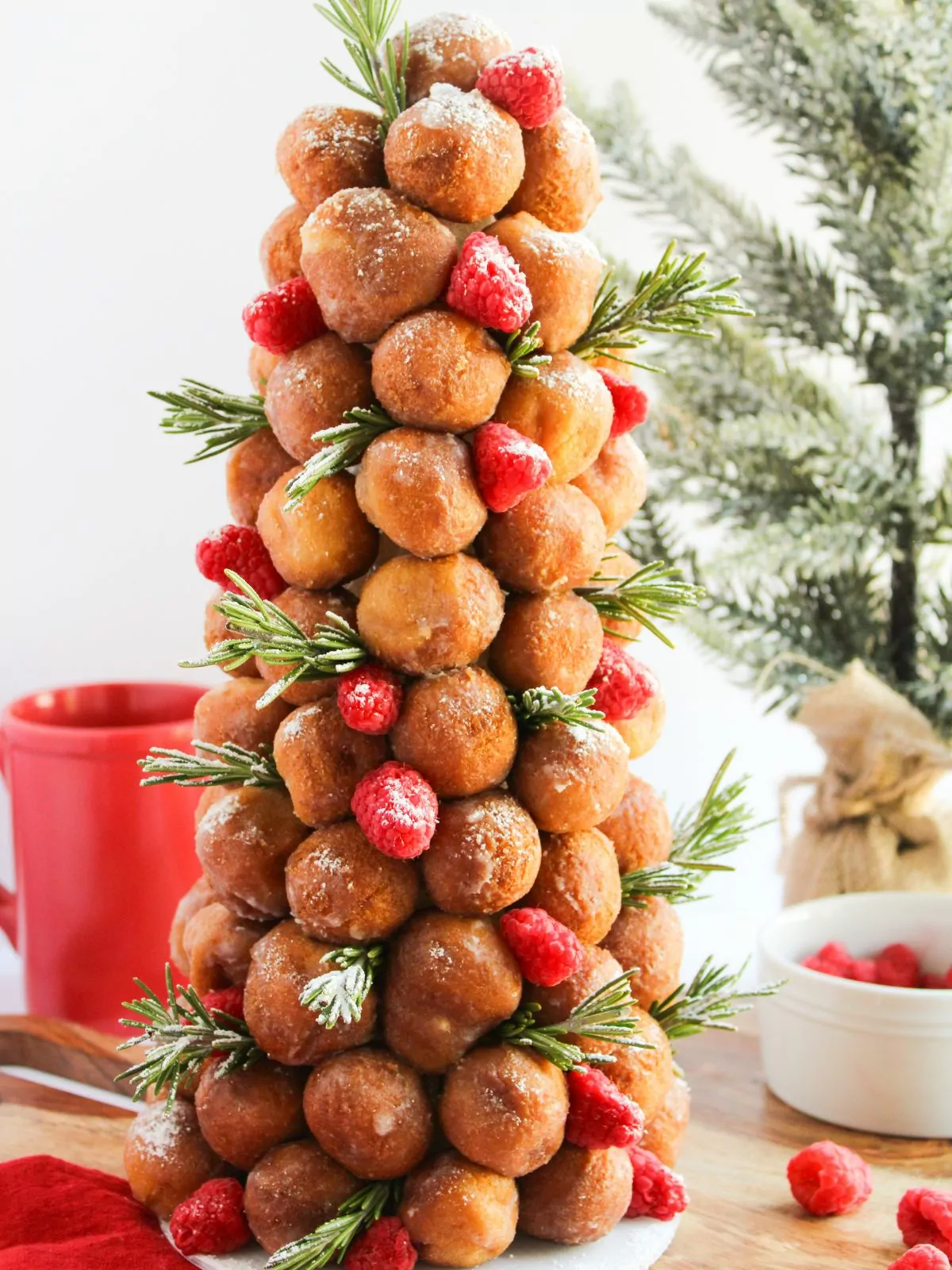 Donut Christmas Tree with raspberries, sprigs of fresh rosemary, and dusted with powdered sugar