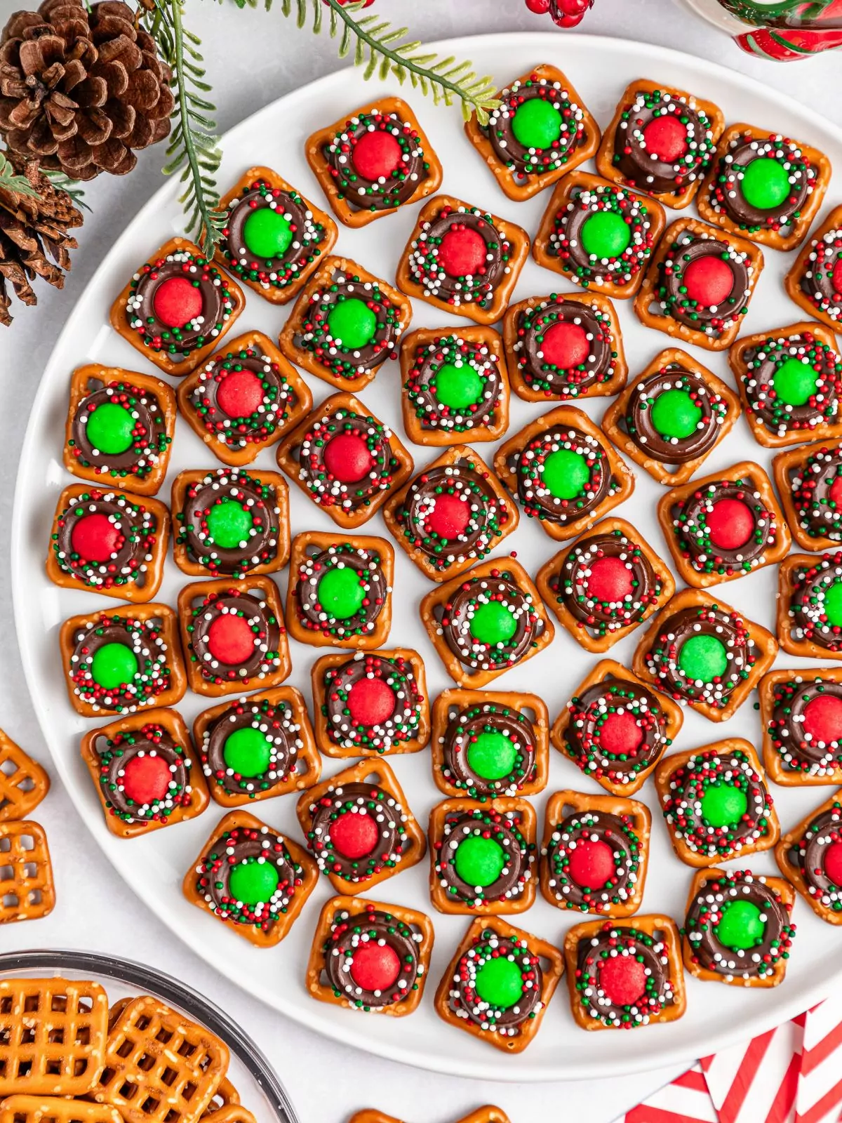 large white platter with pretzel rolo bites with red and green M&M's on each