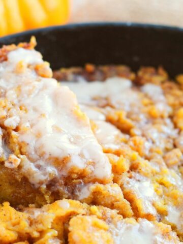 closeup of pumpkin coffee cake with slice being served.