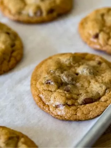 chocolate chip cookies on baking tray with parchment paper.